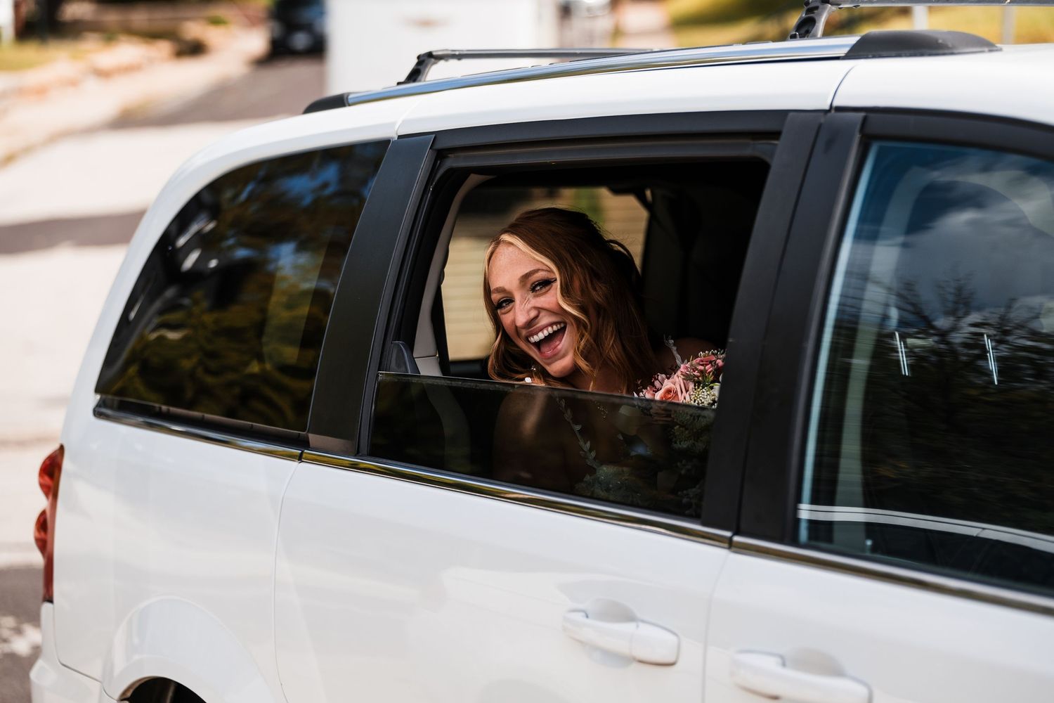 White wedding limousine with happy passengers visible through the windows.