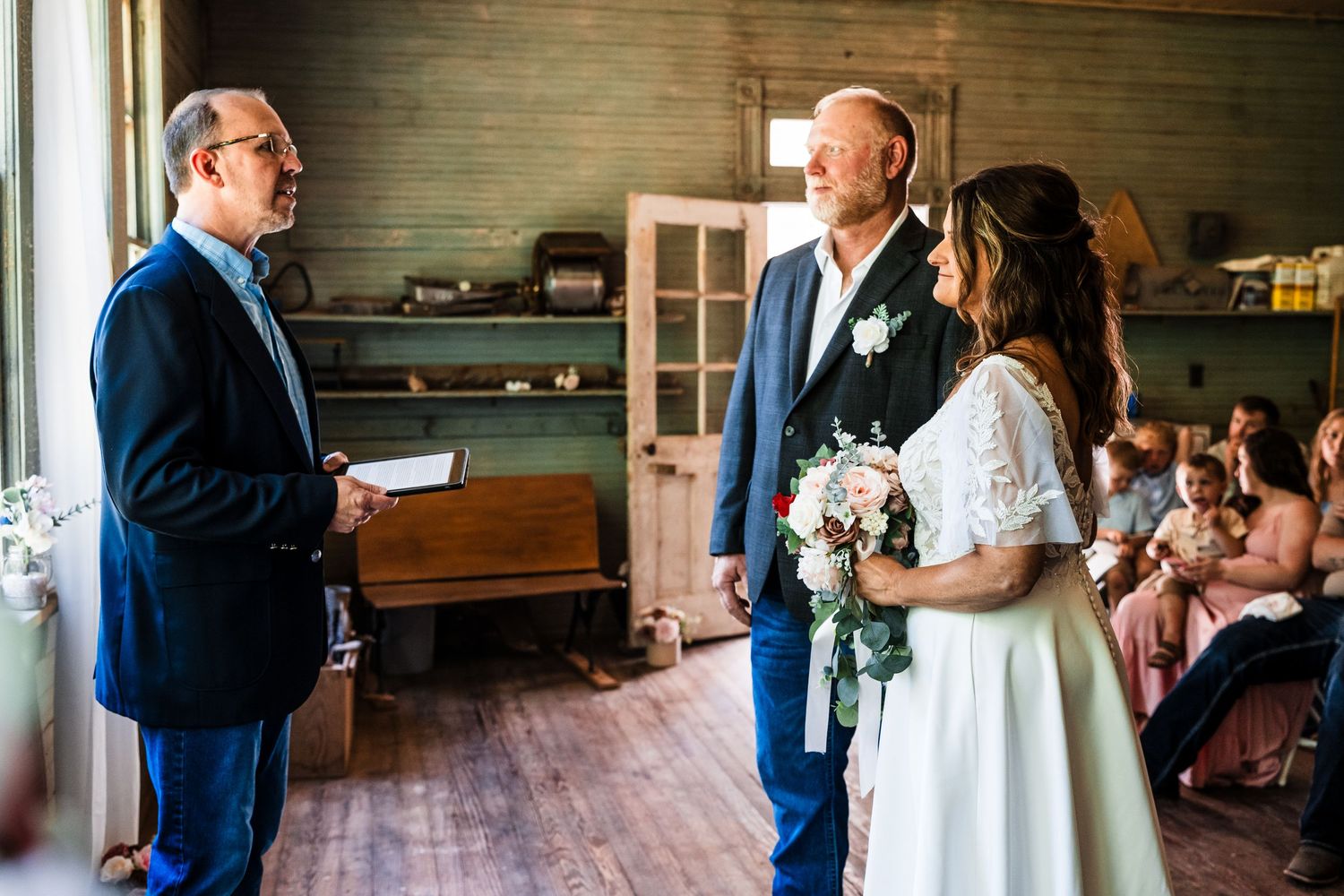Indoor ceremony scene with wooden interior and natural lighting through windows.