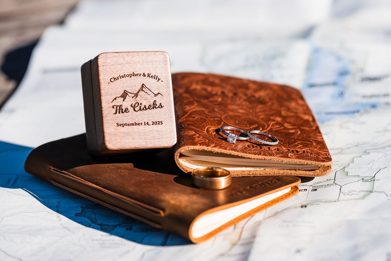 A collection of vintage leather journals and notebooks arranged in a row on a marble surface.