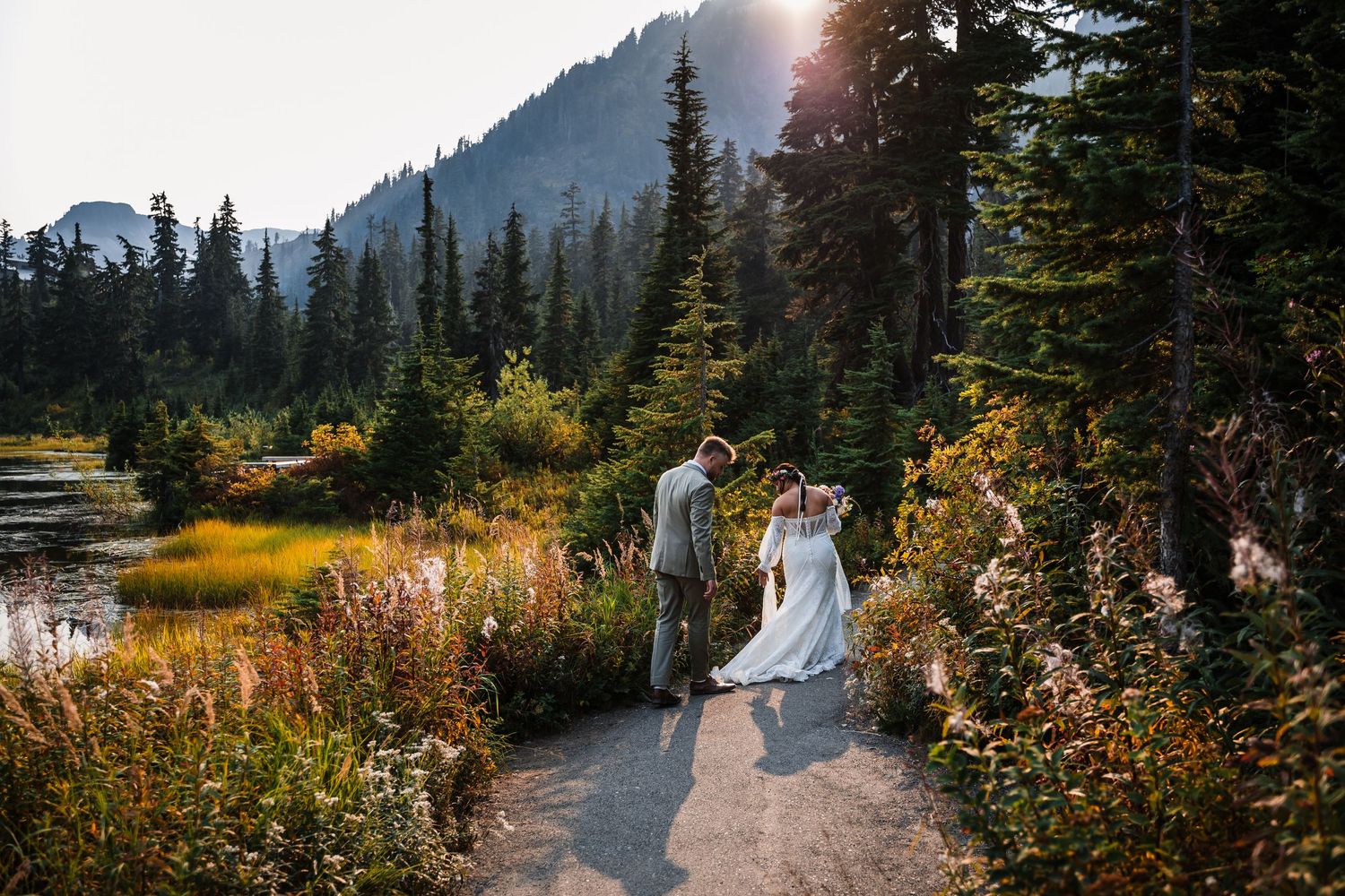 Mountain wedding ceremony site with wildflowers and evergreen forest backdrop.