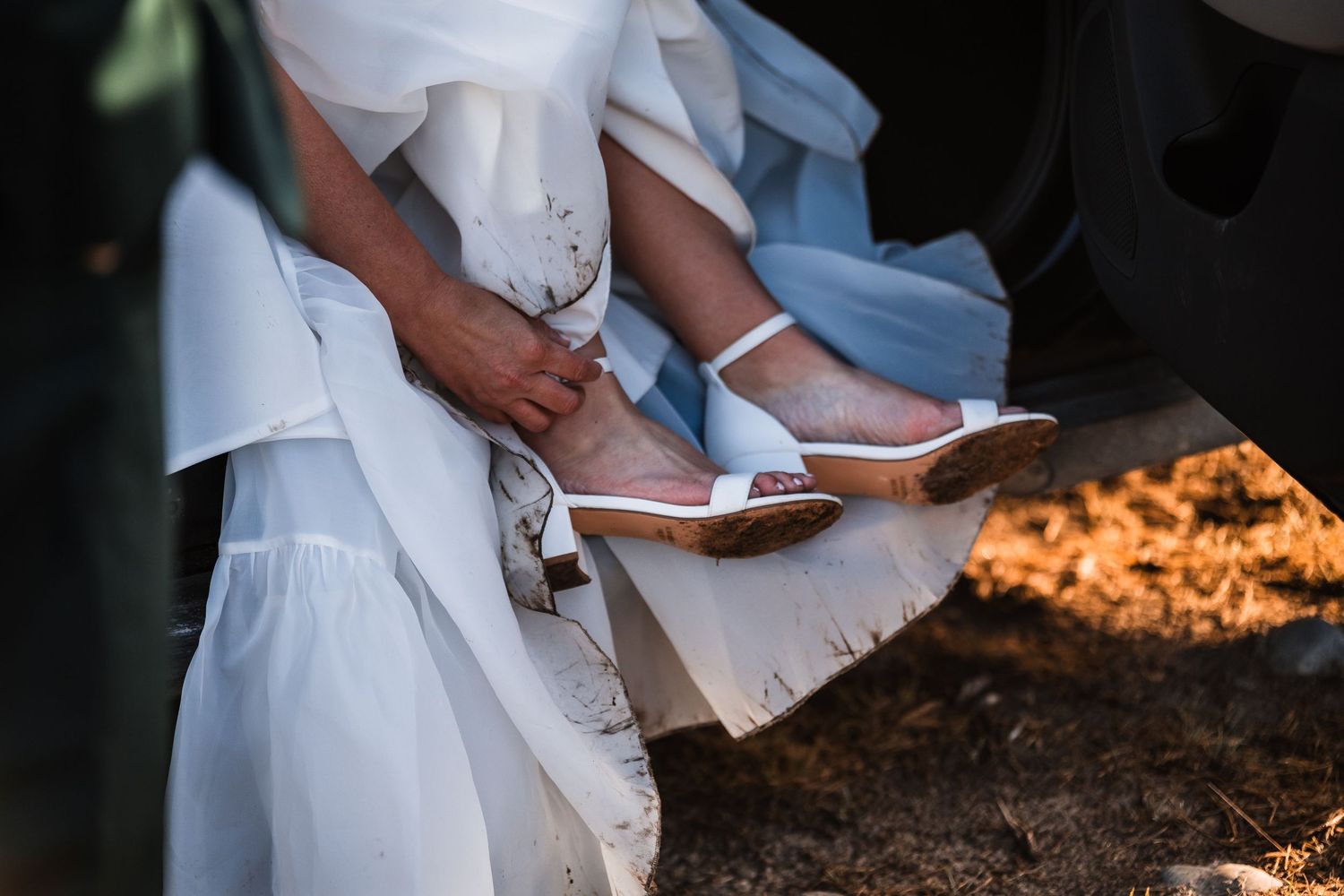 Close-up details of formal wedding attire and accessories in natural lighting.