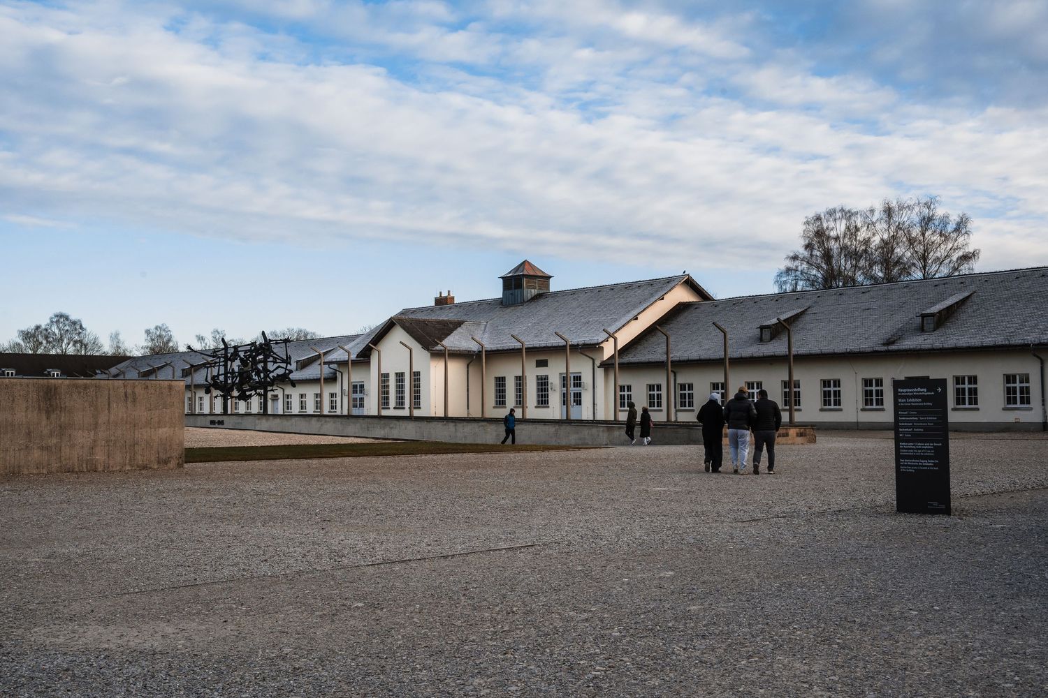 A panoramic view of barracks buildings at Buchenwald concentration camp memorial site under cloudy skies.
