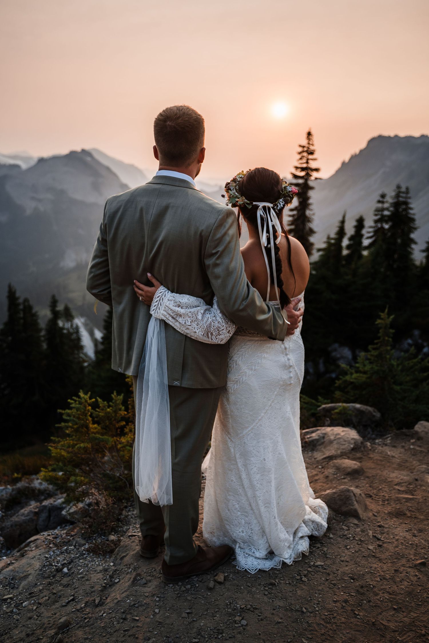 Silhouetted couple embracing at sunset with Mount Baker wilderness views.