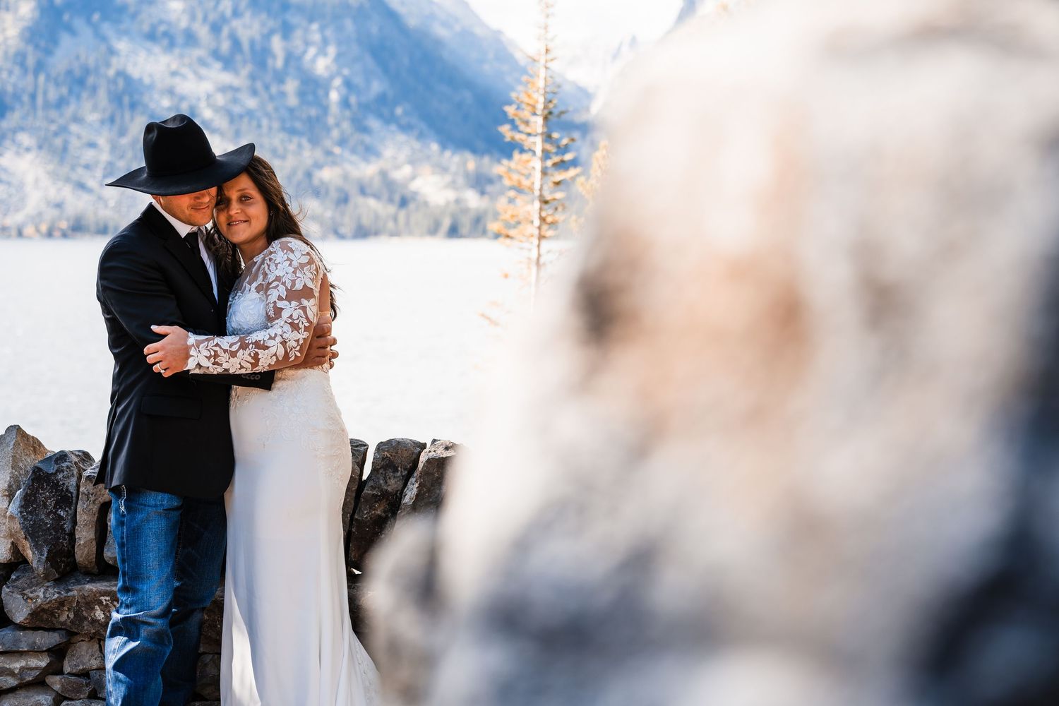An intimate wedding moment captured with majestic mountain peaks in the distance.