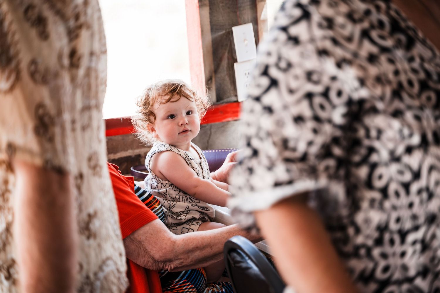 Child watches attentively during indoor wedding celebration.