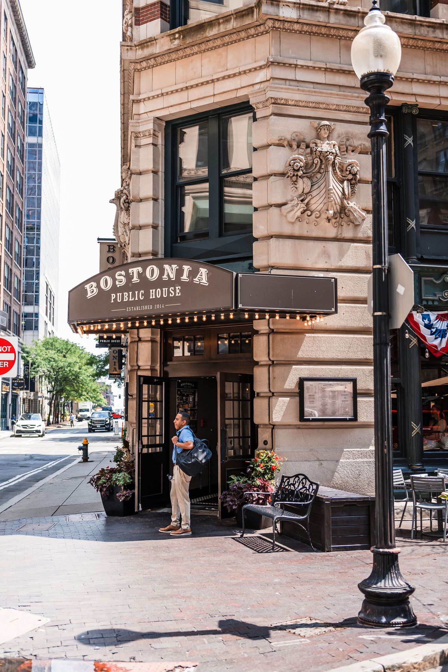 Historic Bostonia Public House exterior with classic architecture and street lamp in downtown setting.