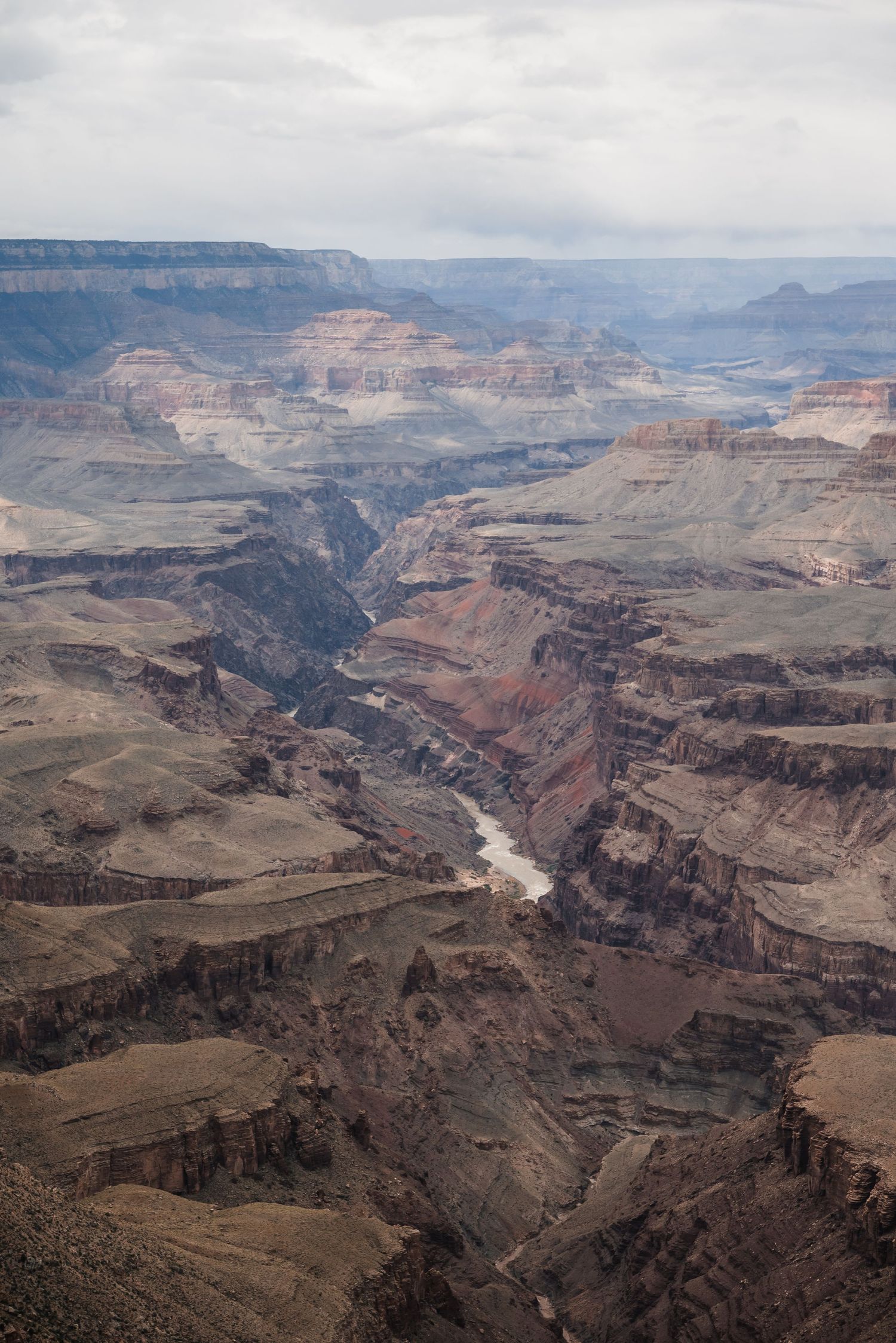 Aerial perspective of the Grand Canyon revealing the Colorado River snaking through dramatic desert terrain.