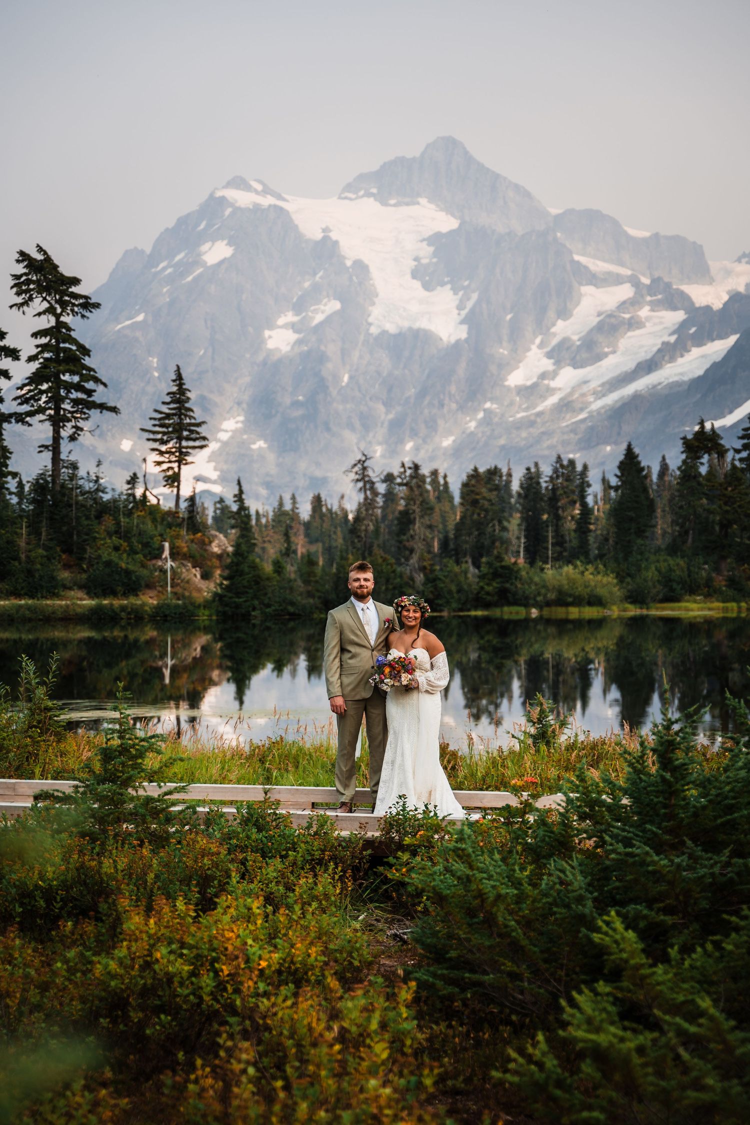 Scenic mountain wedding ceremony setup with snow-capped peaks reflecting in Picture Lake.