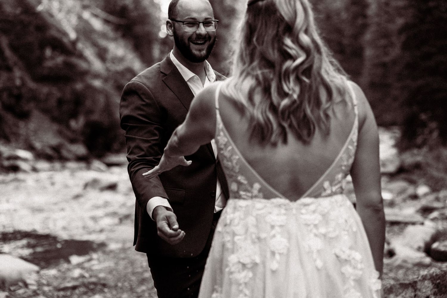 Candid black and white wedding moments captured in an outdoor setting.