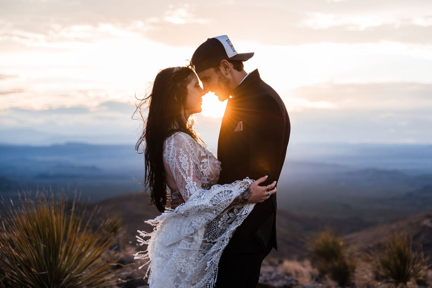 Romantic sunset silhouettes against a mountain landscape backdrop.