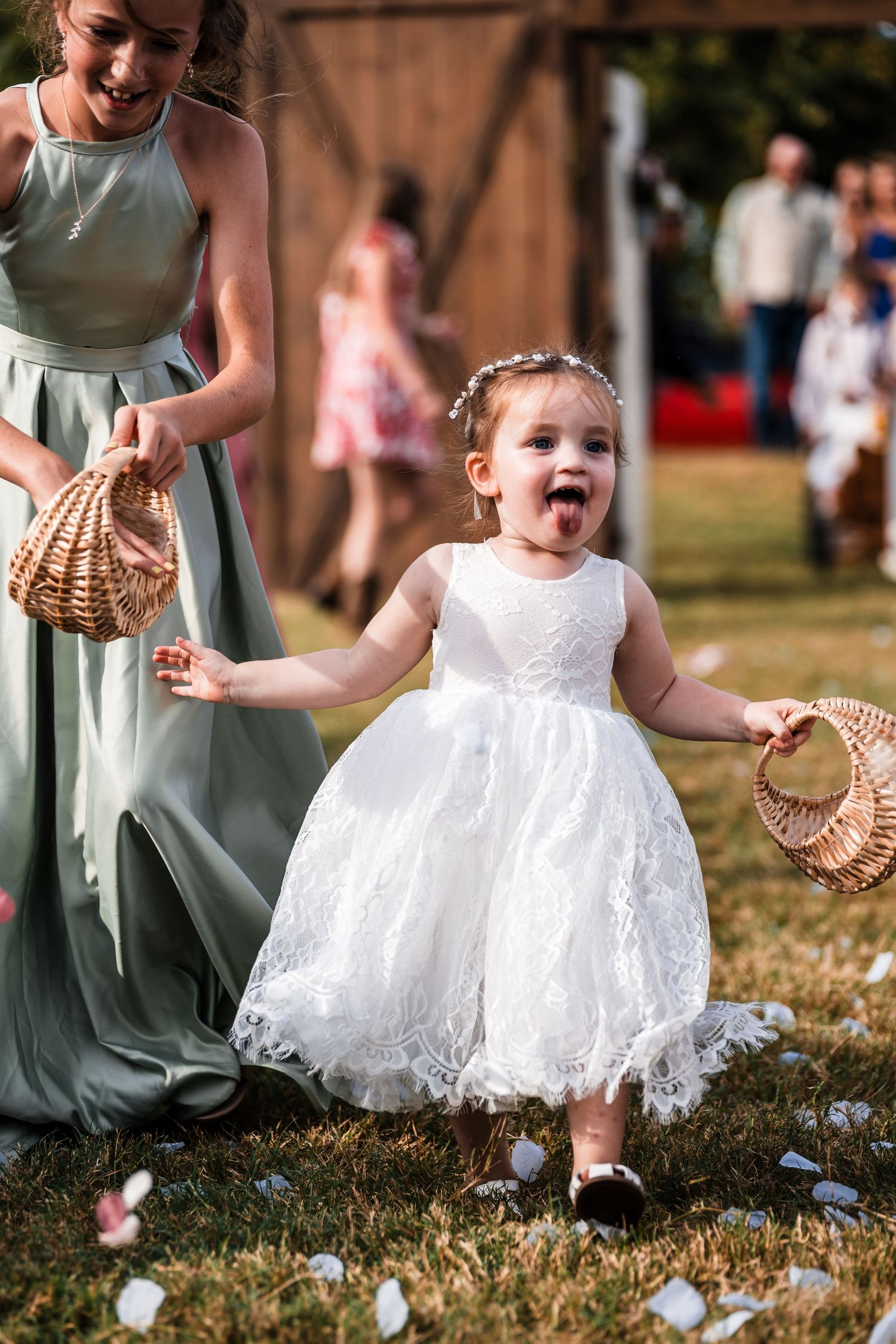 A playful scene in a grassy field with flowing dresses and woven baskets.