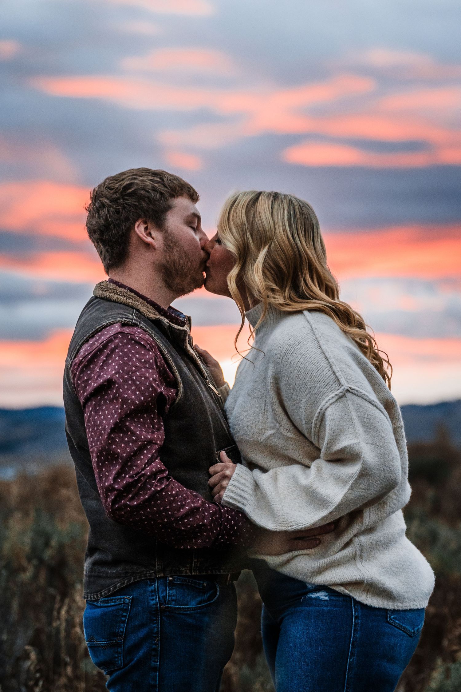 A romantic couple shares intimate moments against a vibrant sunset sky in a series of connected photos.