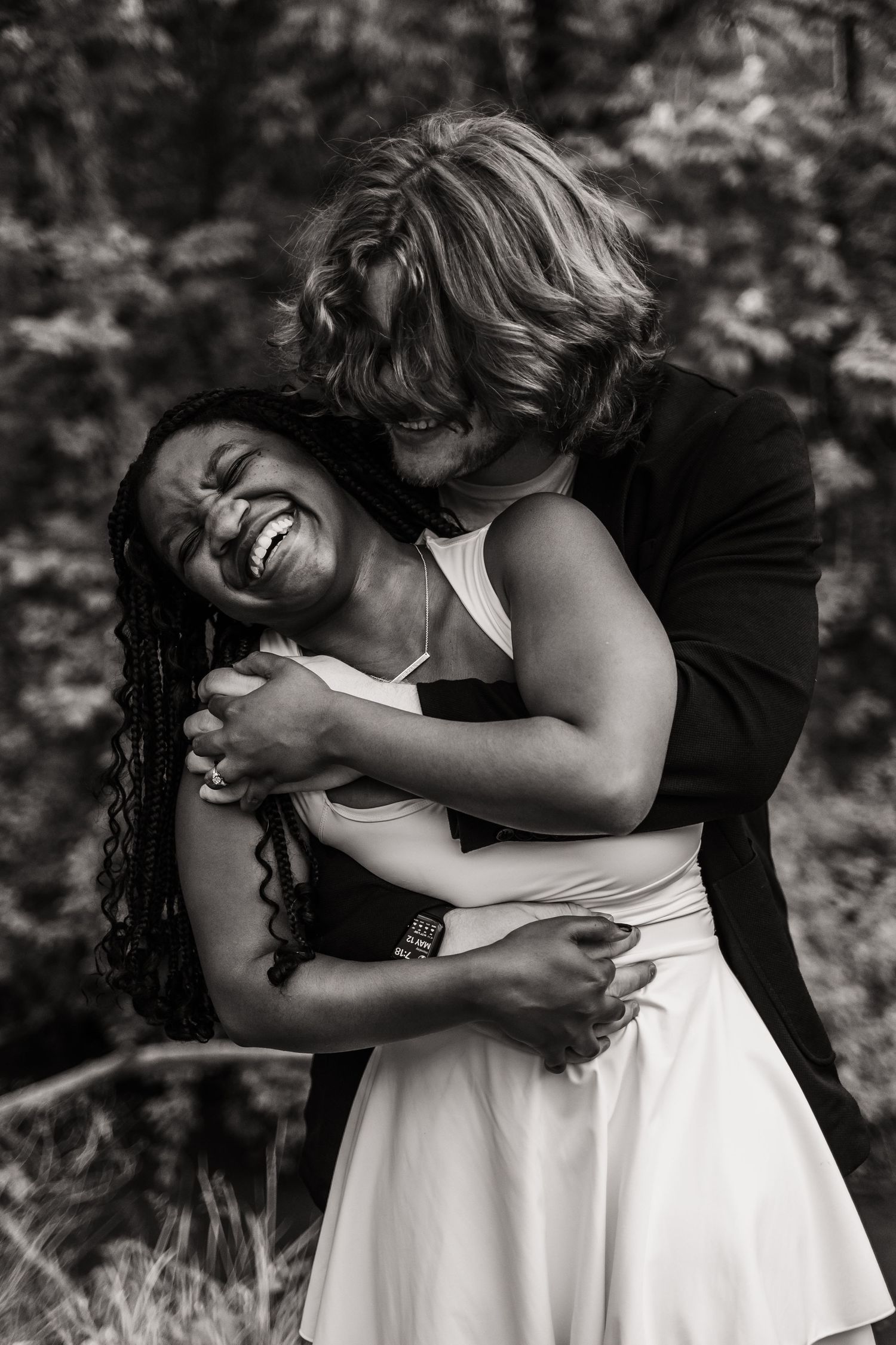 A heartwarming black and white photo sequence shows two people sharing a joyful embrace in an outdoor setting.