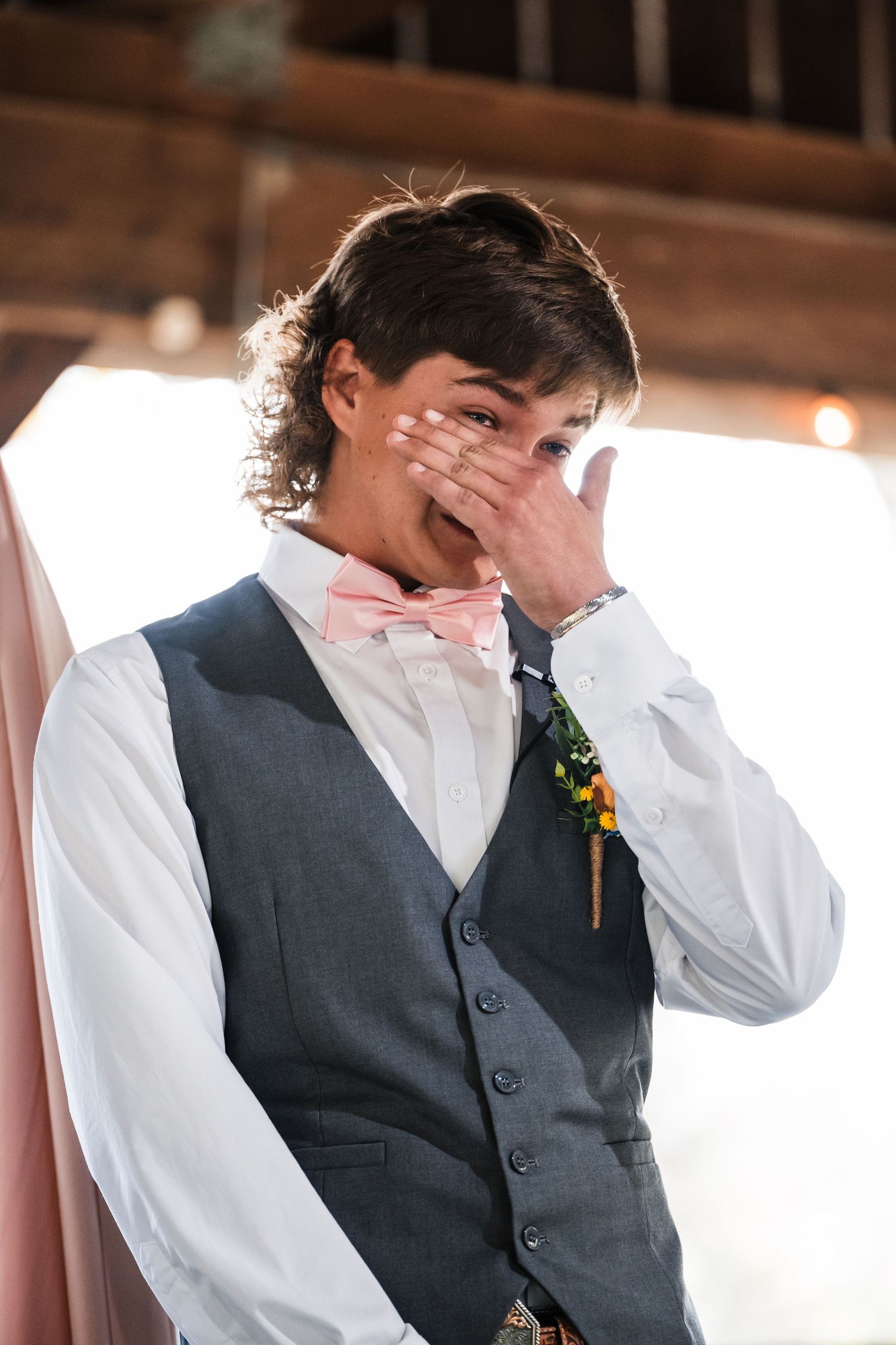 An emotional moment captured during a wedding ceremony showing a heartfelt reaction.
