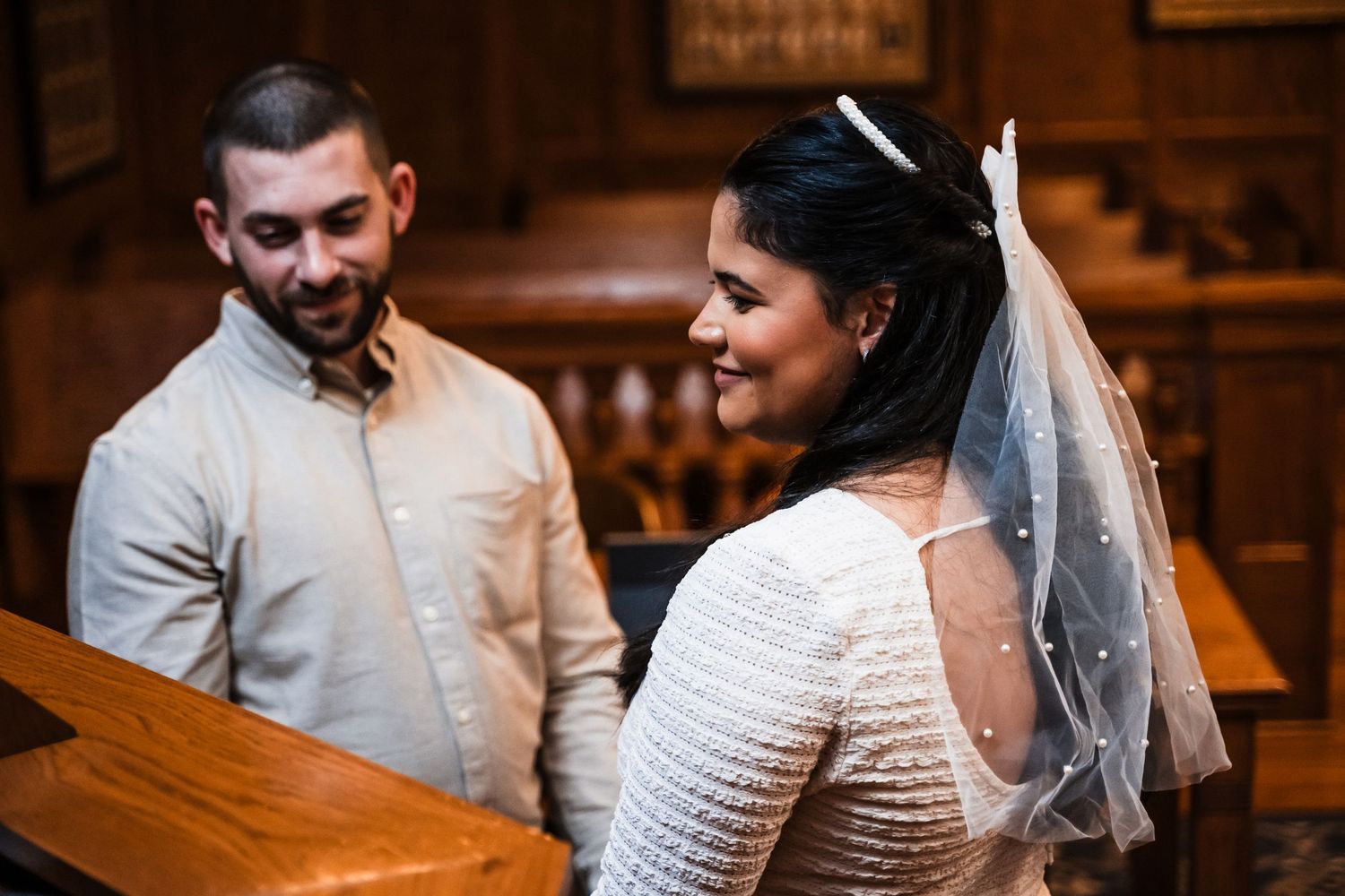 An intimate courthouse ceremony captured in warm indoor lighting.