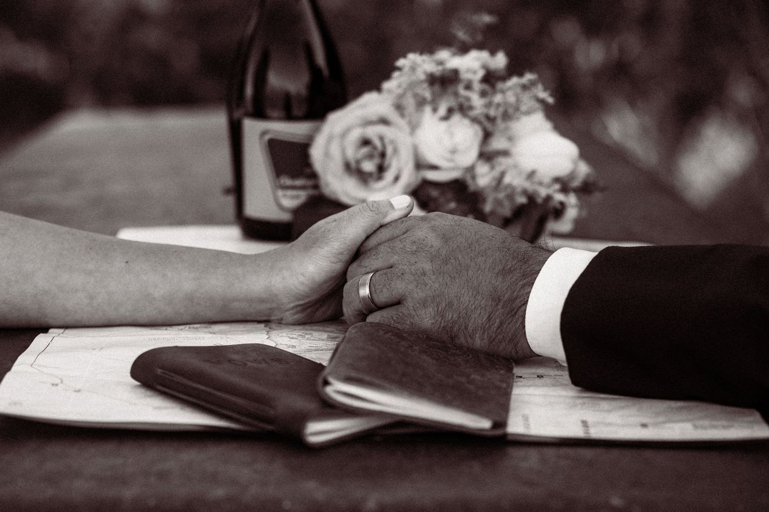 A series of black and white photographs showing hands writing and working with documents on a desk.