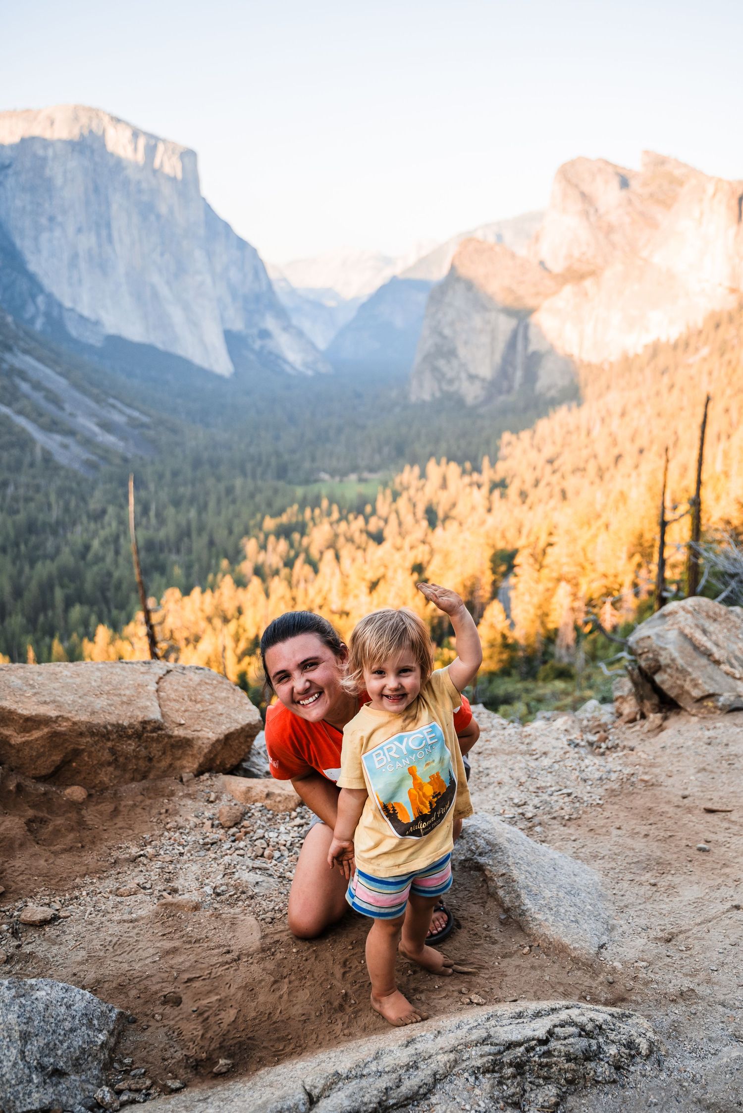 Scenic view of Yosemite Valley with El Capitan and Half Dome mountains during golden hour.