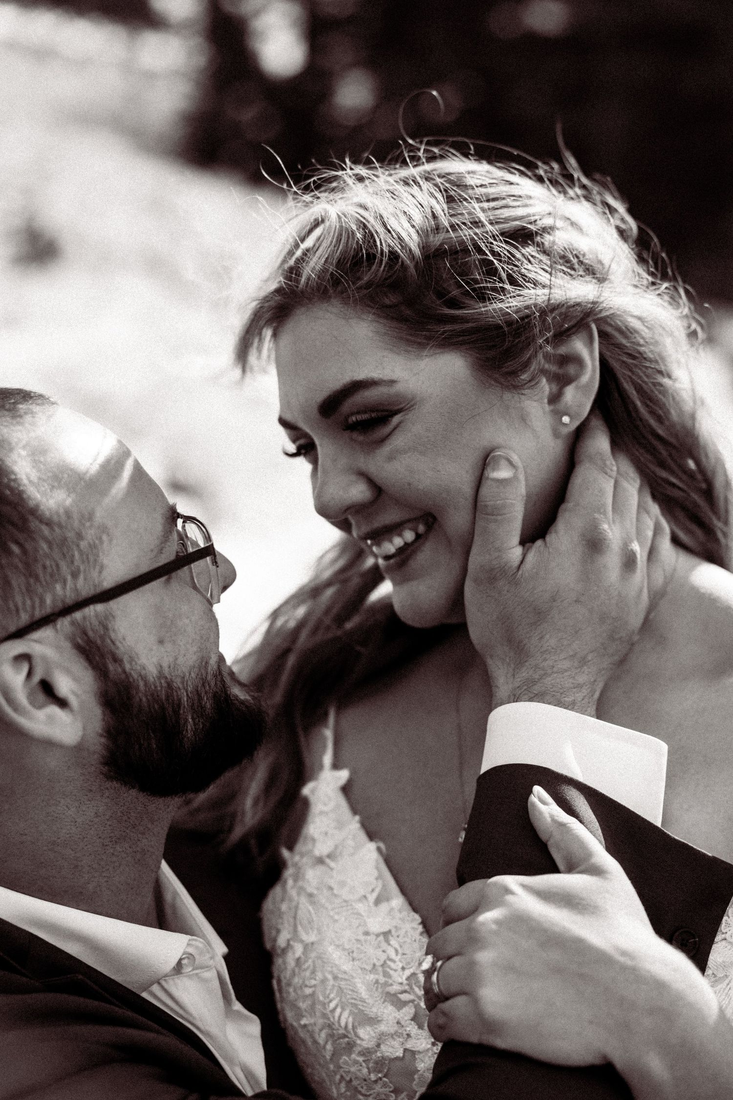 Intimate black and white portrait of couple sharing a tender moment.