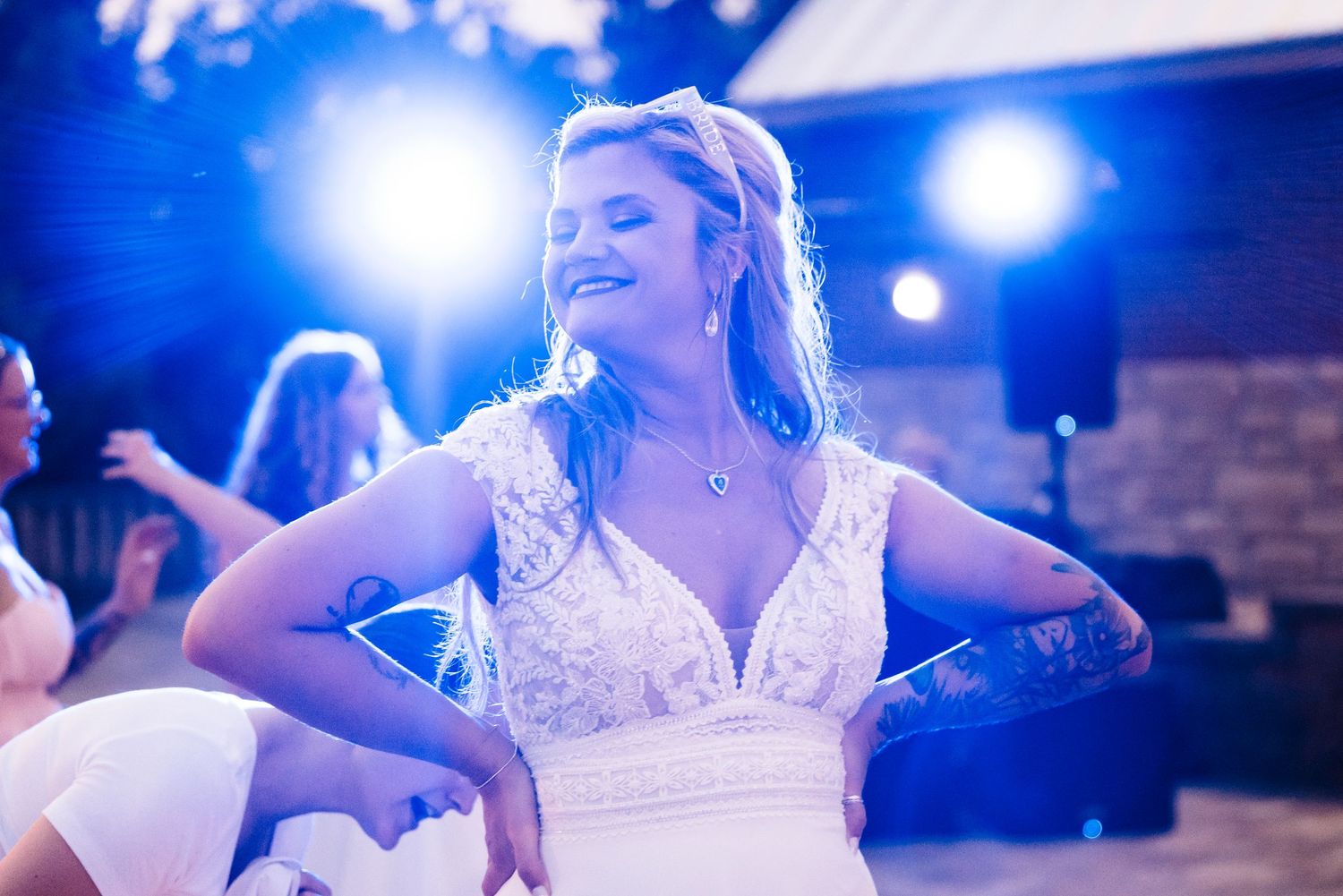 Dance floor scenes with blue lighting and festive atmosphere at a wedding reception.