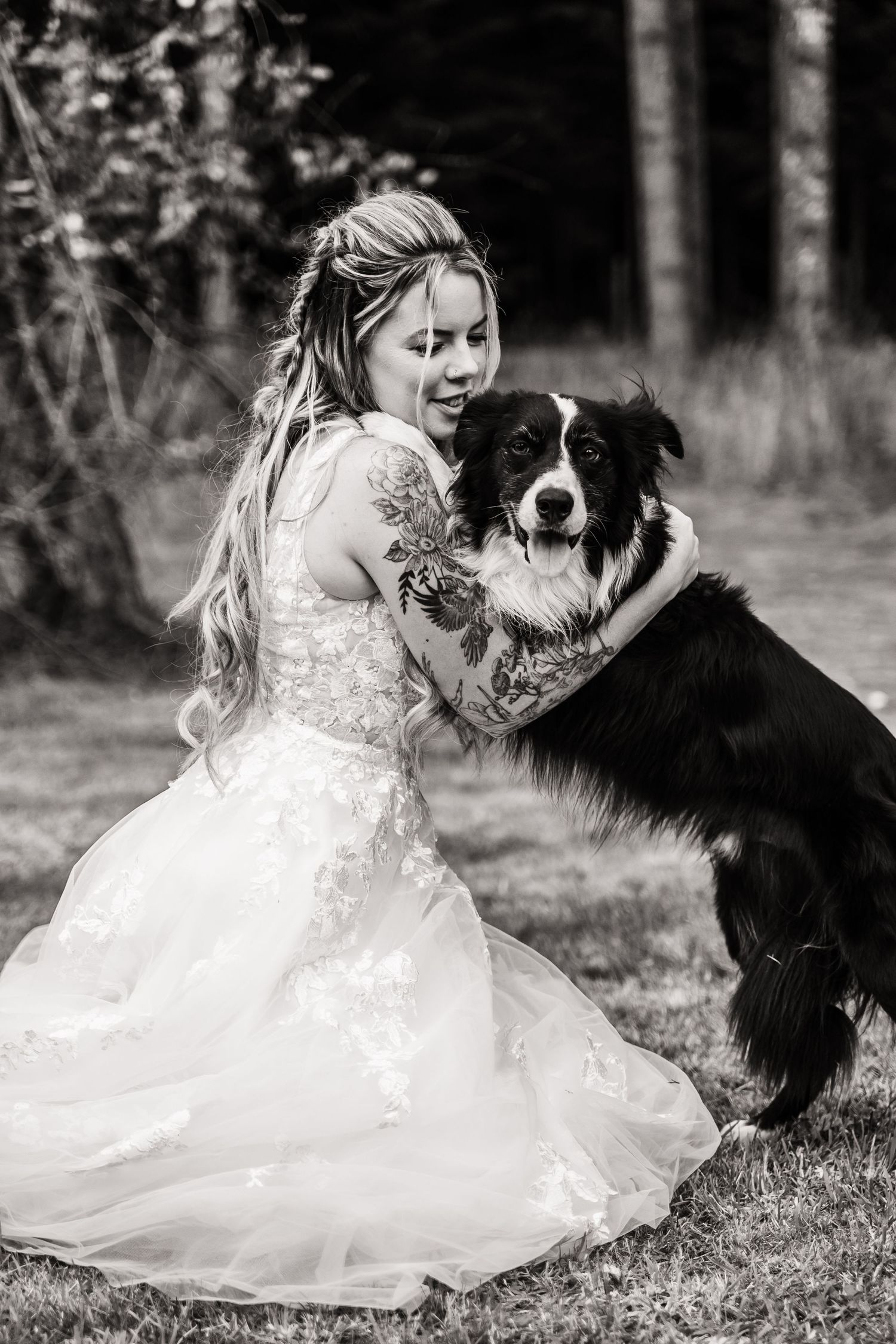 A black and white photo series shows a child in a white dress playing with a Border Collie dog in a grassy field.