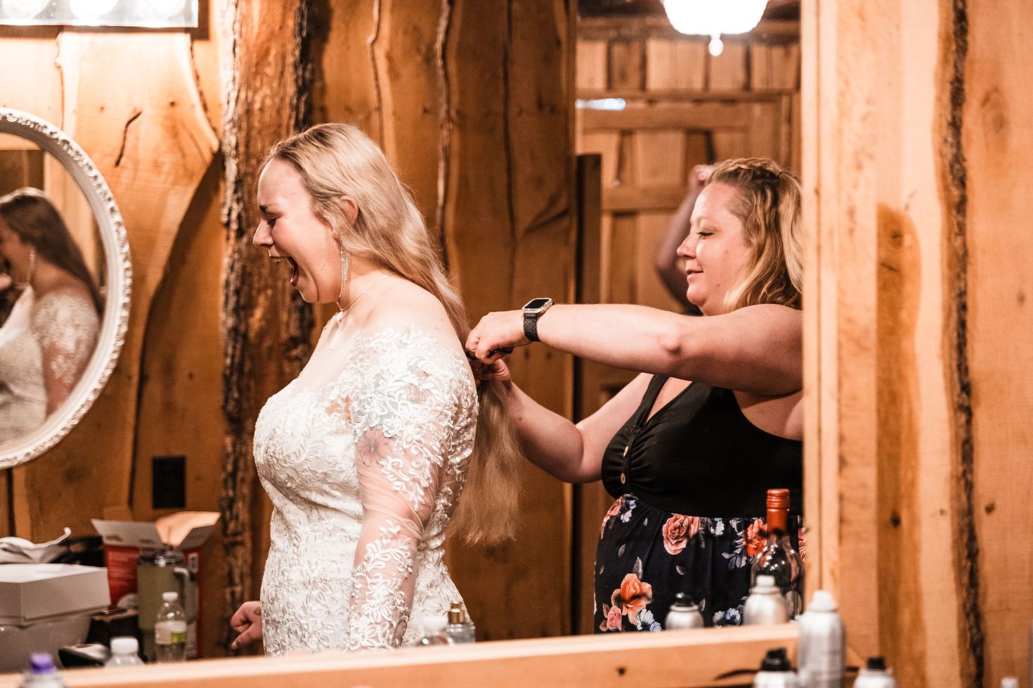 A bridal preparation scene shows final touches being made to a wedding dress in a rustic wood-paneled room.