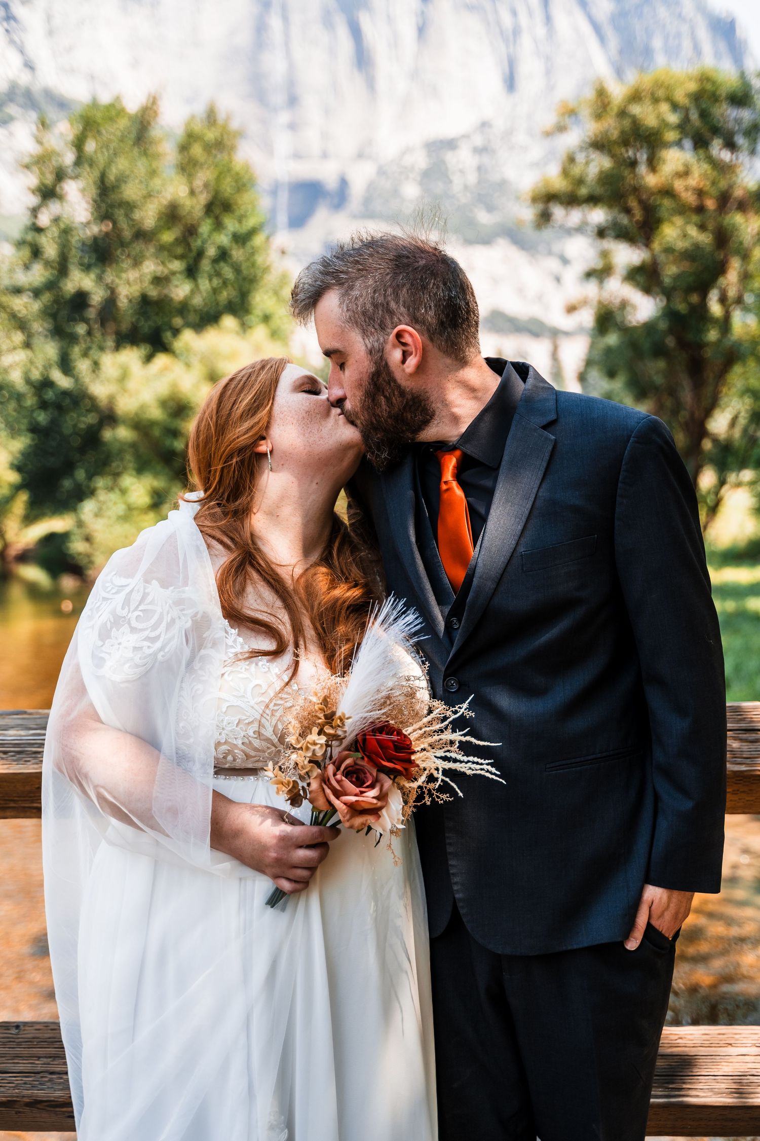 A series of romantic wedding photos showing a couple kissing on a bench with mountains in the background.