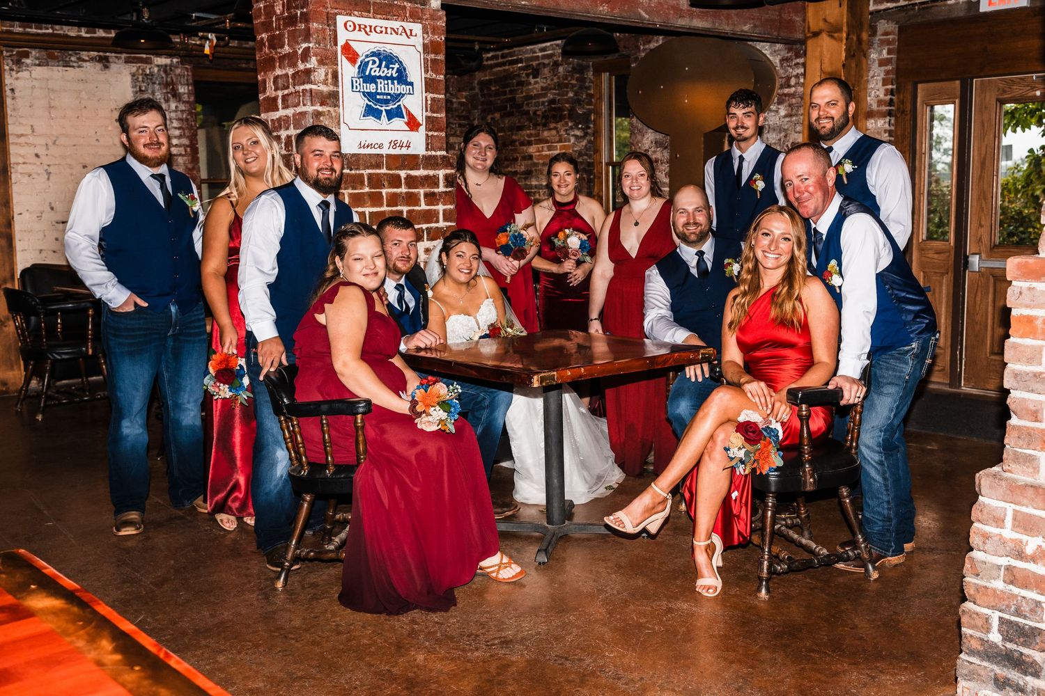 Wedding reception venue with exposed brick walls and guests gathered for celebration.