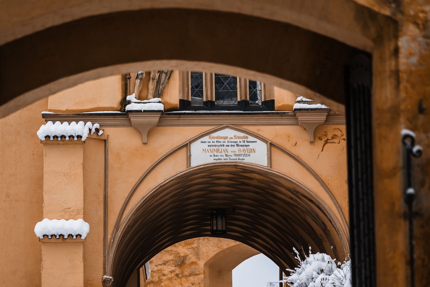 Architectural details of arched stone passageways and columns in a historic European building.