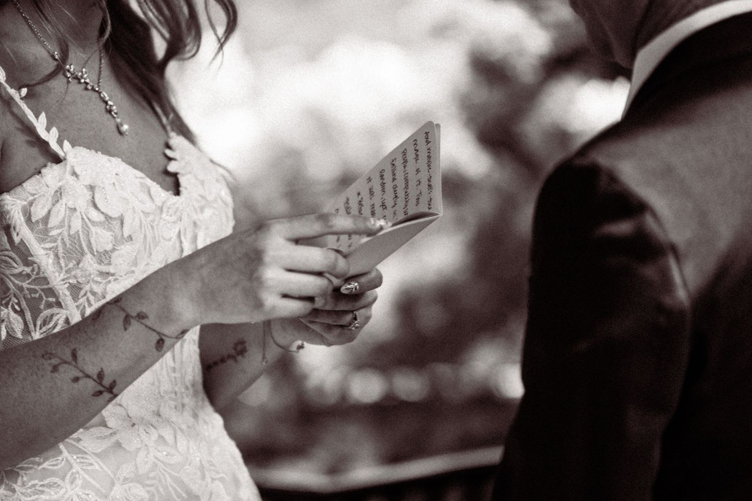Black and white close-up shots of hands exchanging wedding rings during ceremony.