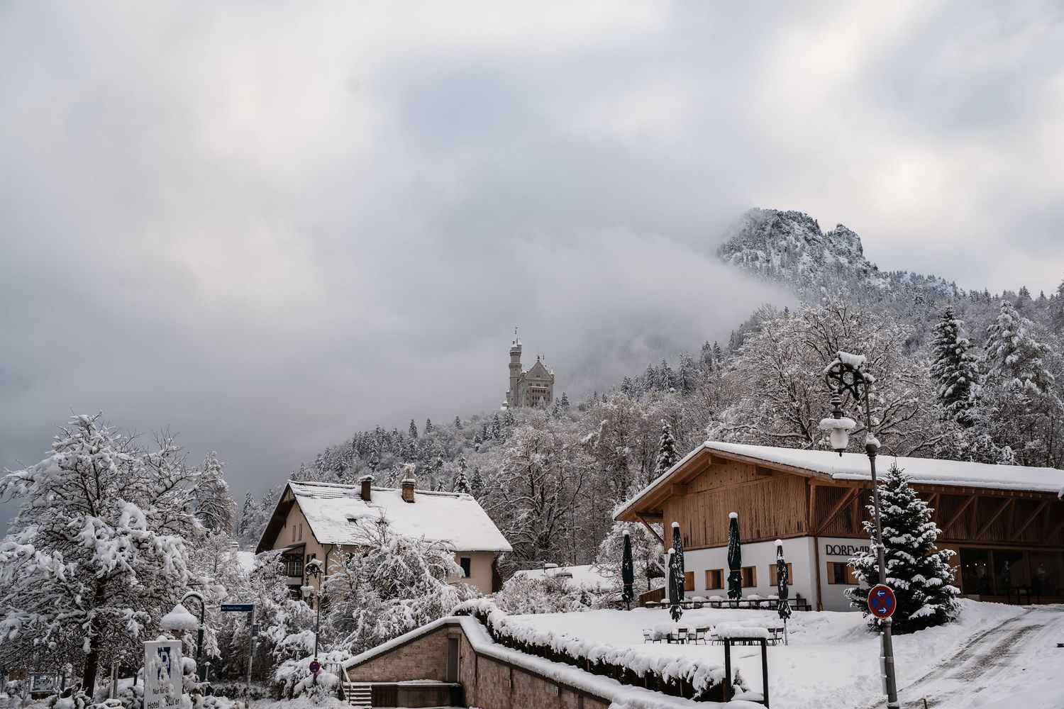 Snow covered mountains and houses create a serene winter landscape in a small village.