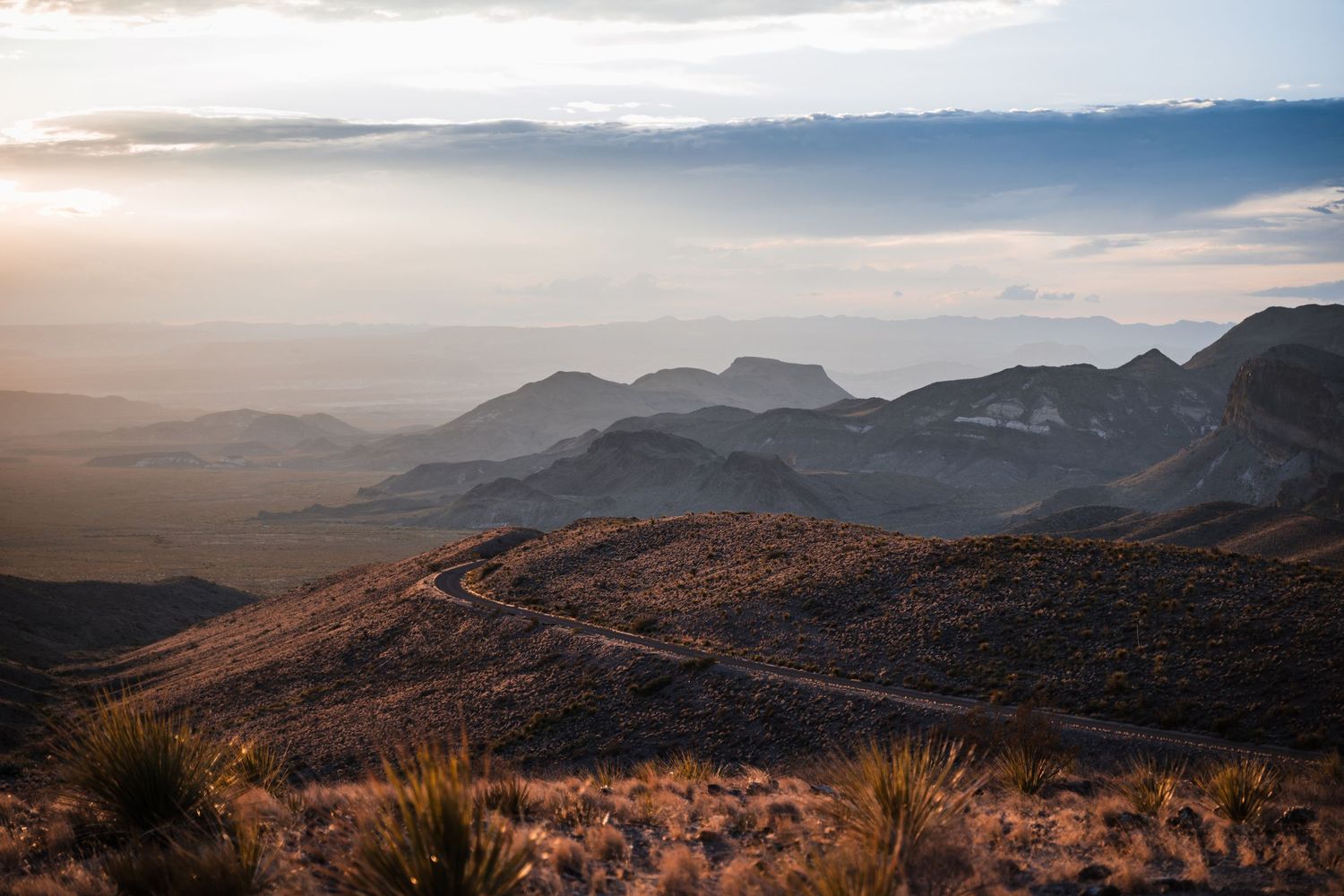 Dramatic sunset view over rugged mountain ranges and desert valleys in Big Bend National Park.
