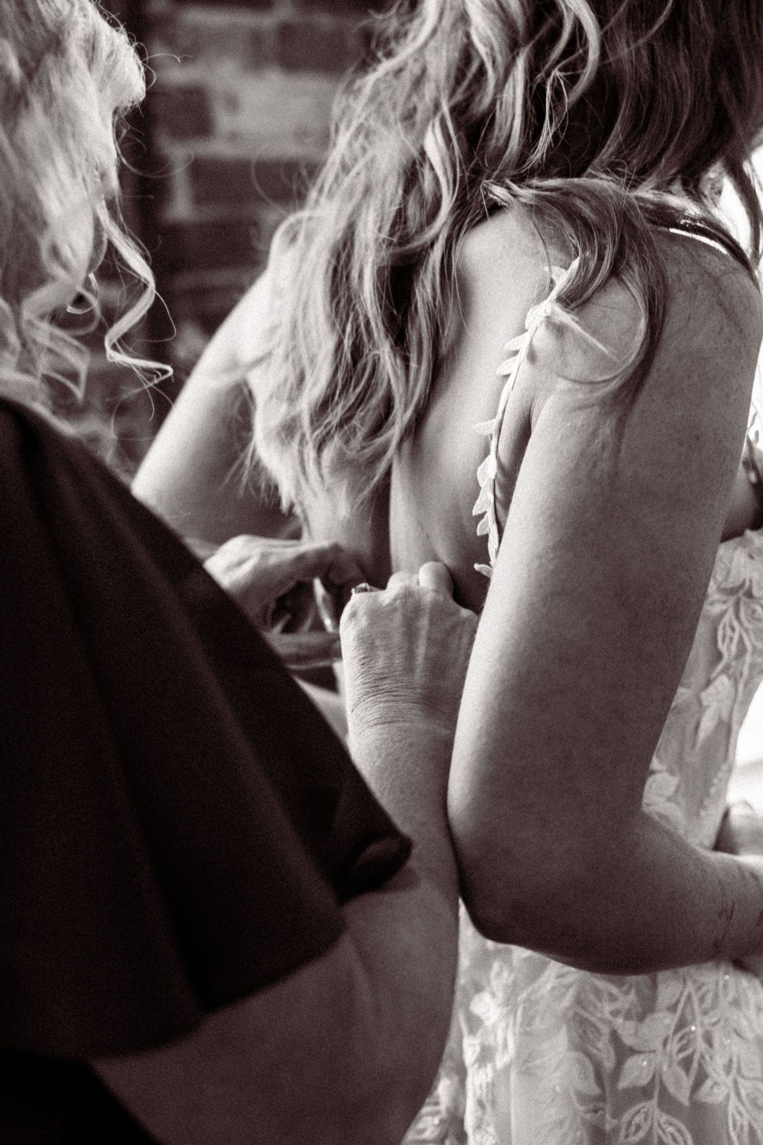 A series of black and white photos showing tender moments between a couple during an intimate wedding ceremony.