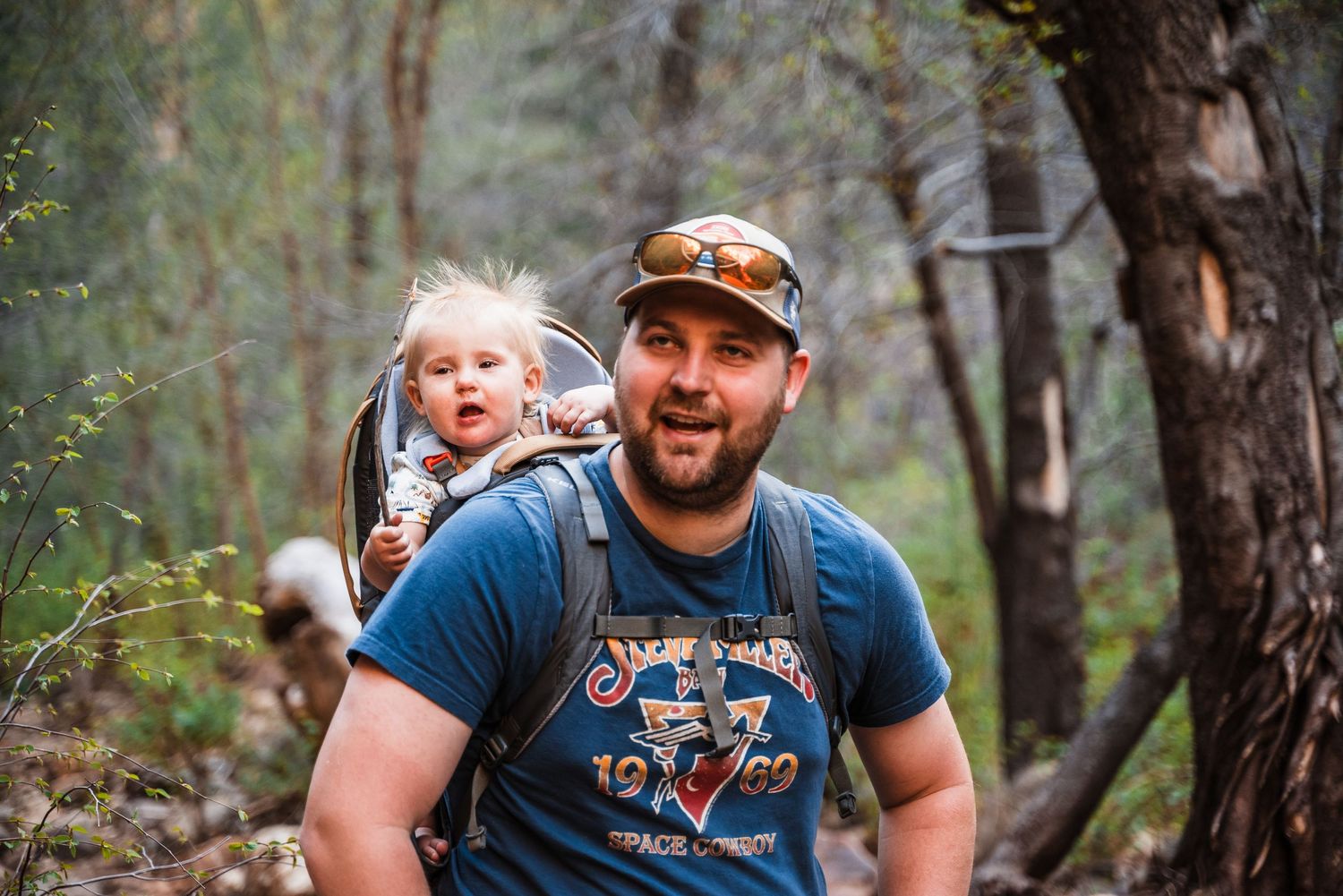 Happy outdoor adventurers enjoying a hike through a scenic wooded trail.
