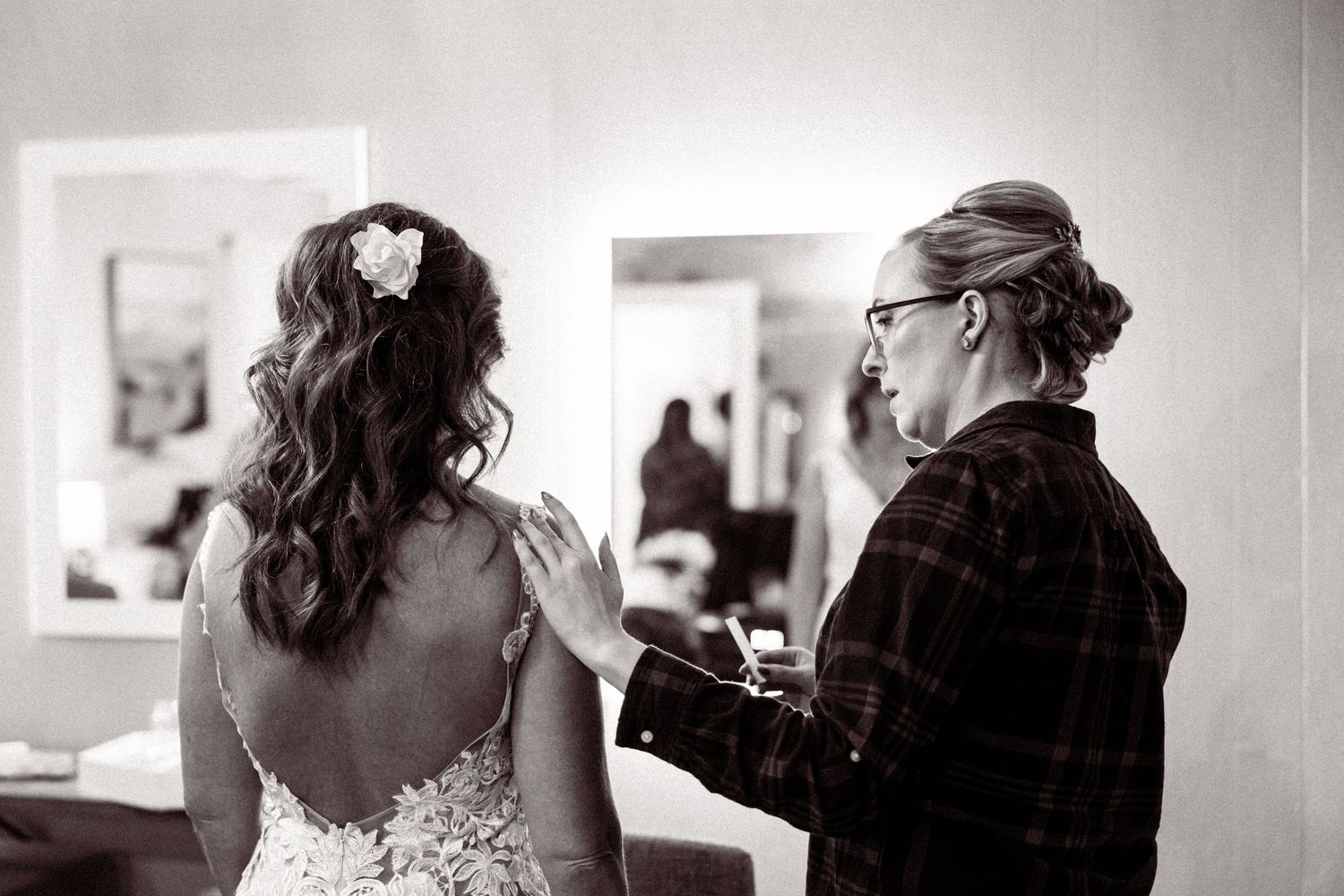 Black and white wedding photography captures tender moments between newlyweds.