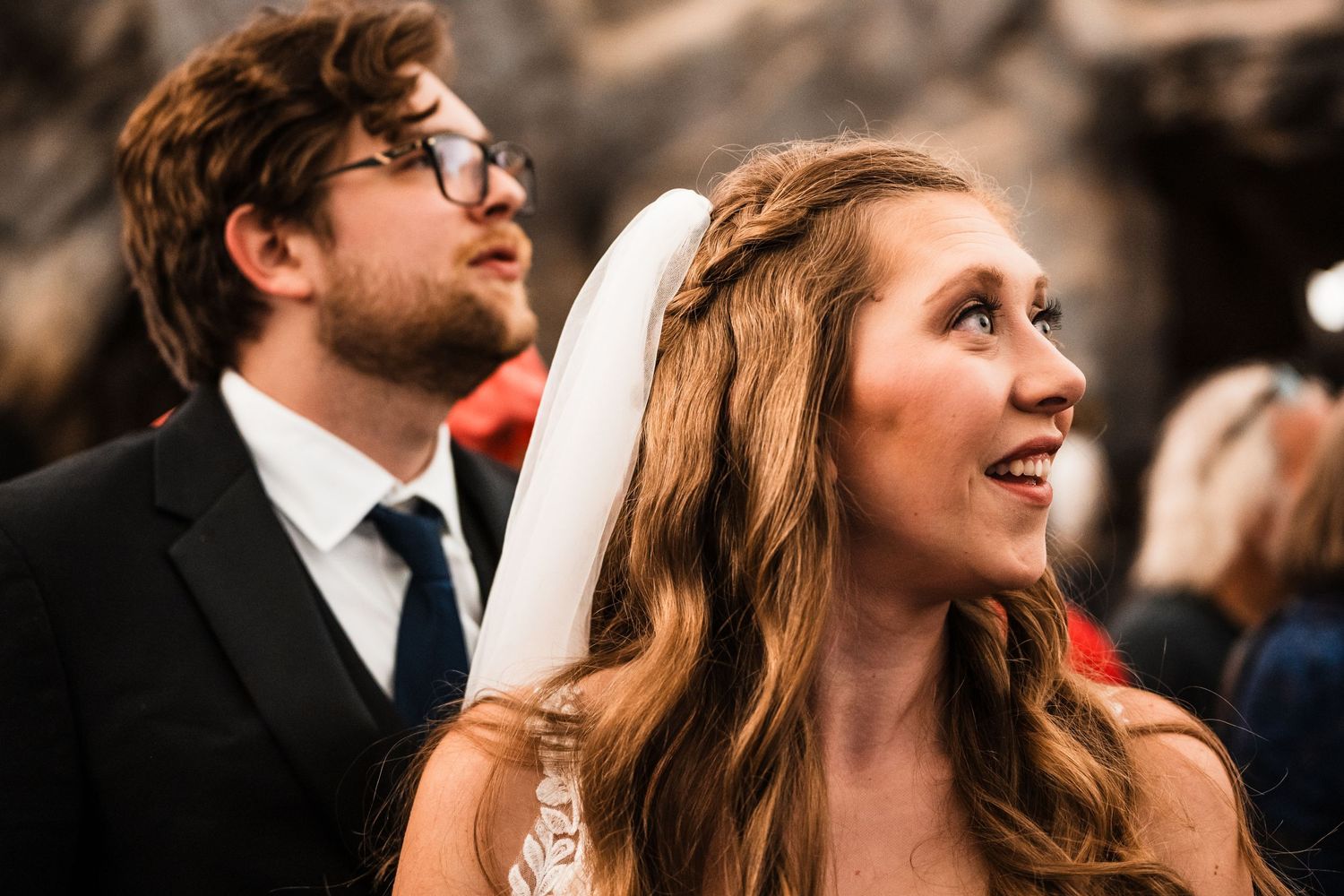 Candid wedding moment captured during outdoor ceremony.