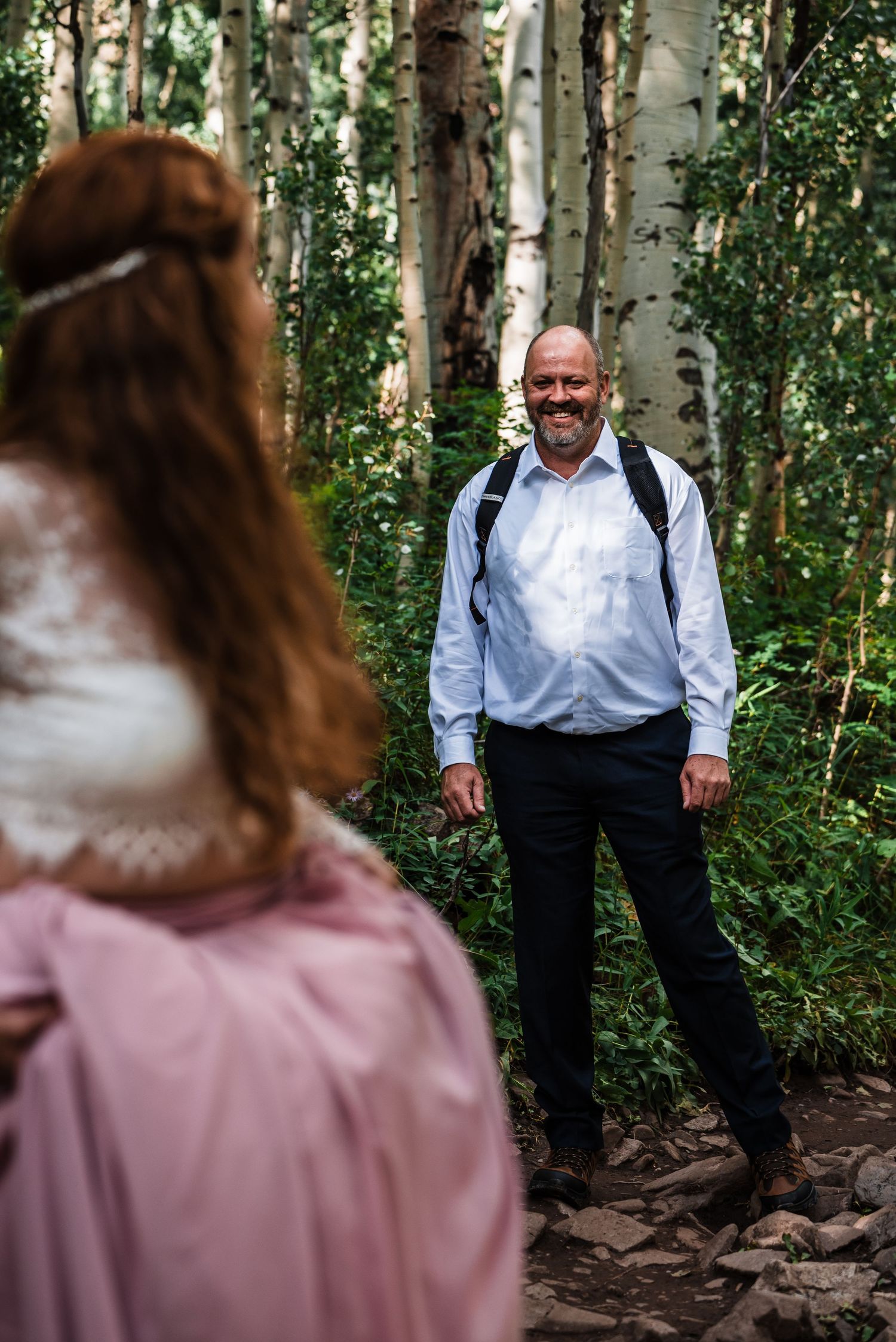 A tender moment captured between two people in an aspen grove.