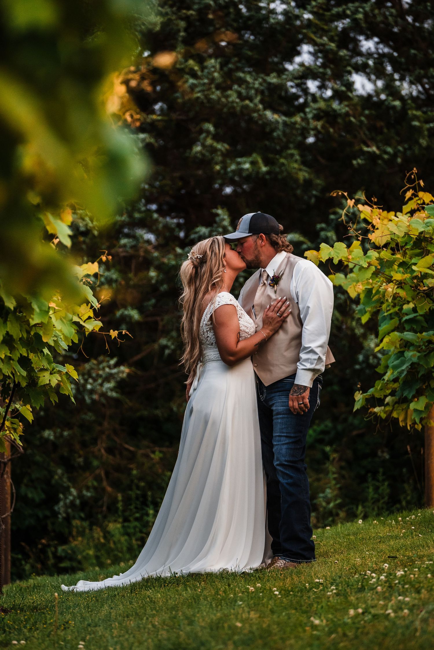 A romantic garden wedding photoshoot showing tender moments between a couple among lush greenery.