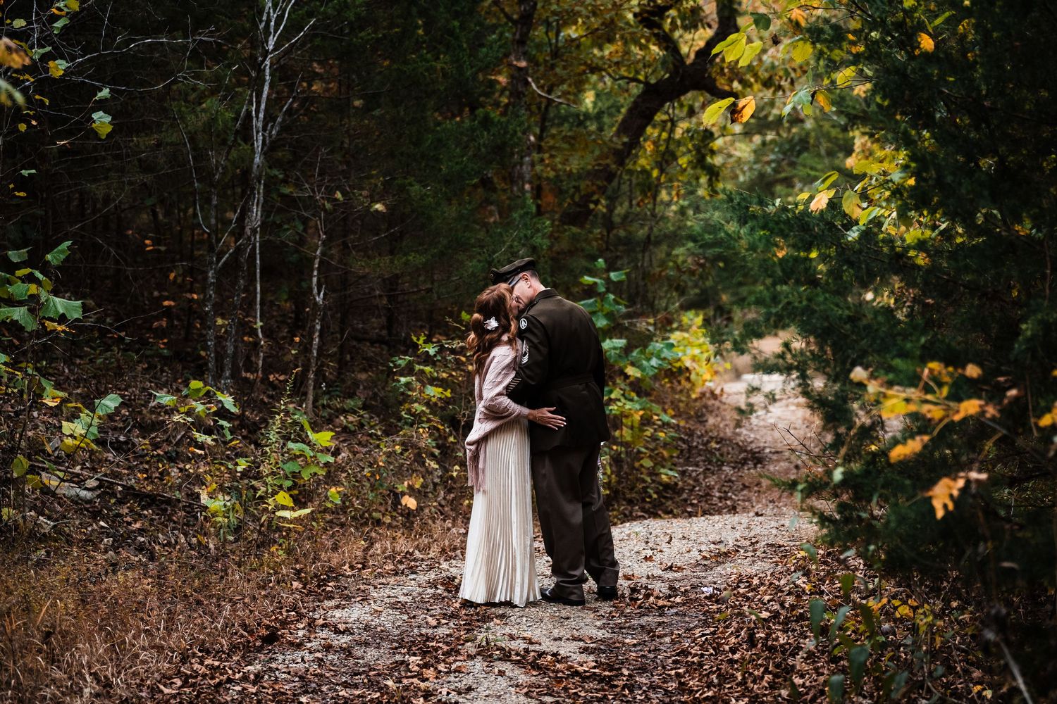 Autumn wedding portrait session with fall foliage in the background.