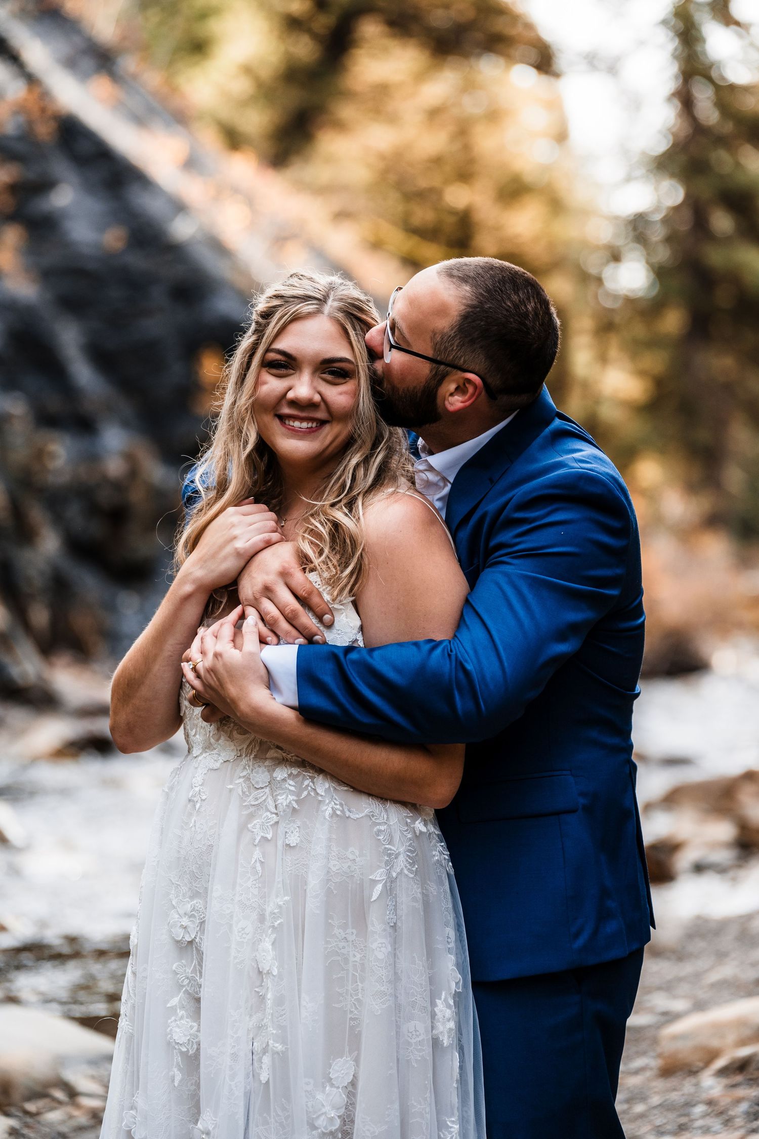 A couple in wedding attire share intimate moments against a snowy outdoor backdrop.