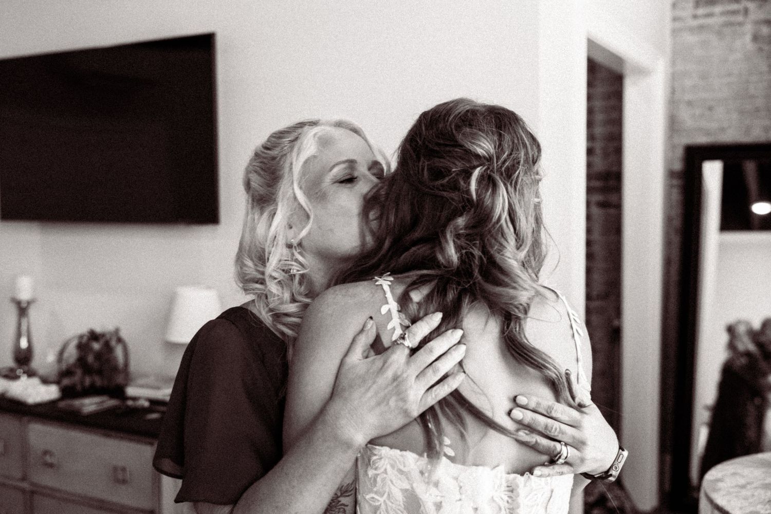 Black and white photos capture intimate moments during wedding day preparations.