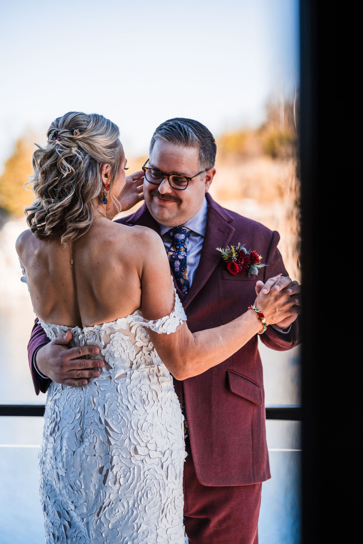 Couple sharing intimate dance moment during wedding reception by scenic quarry.