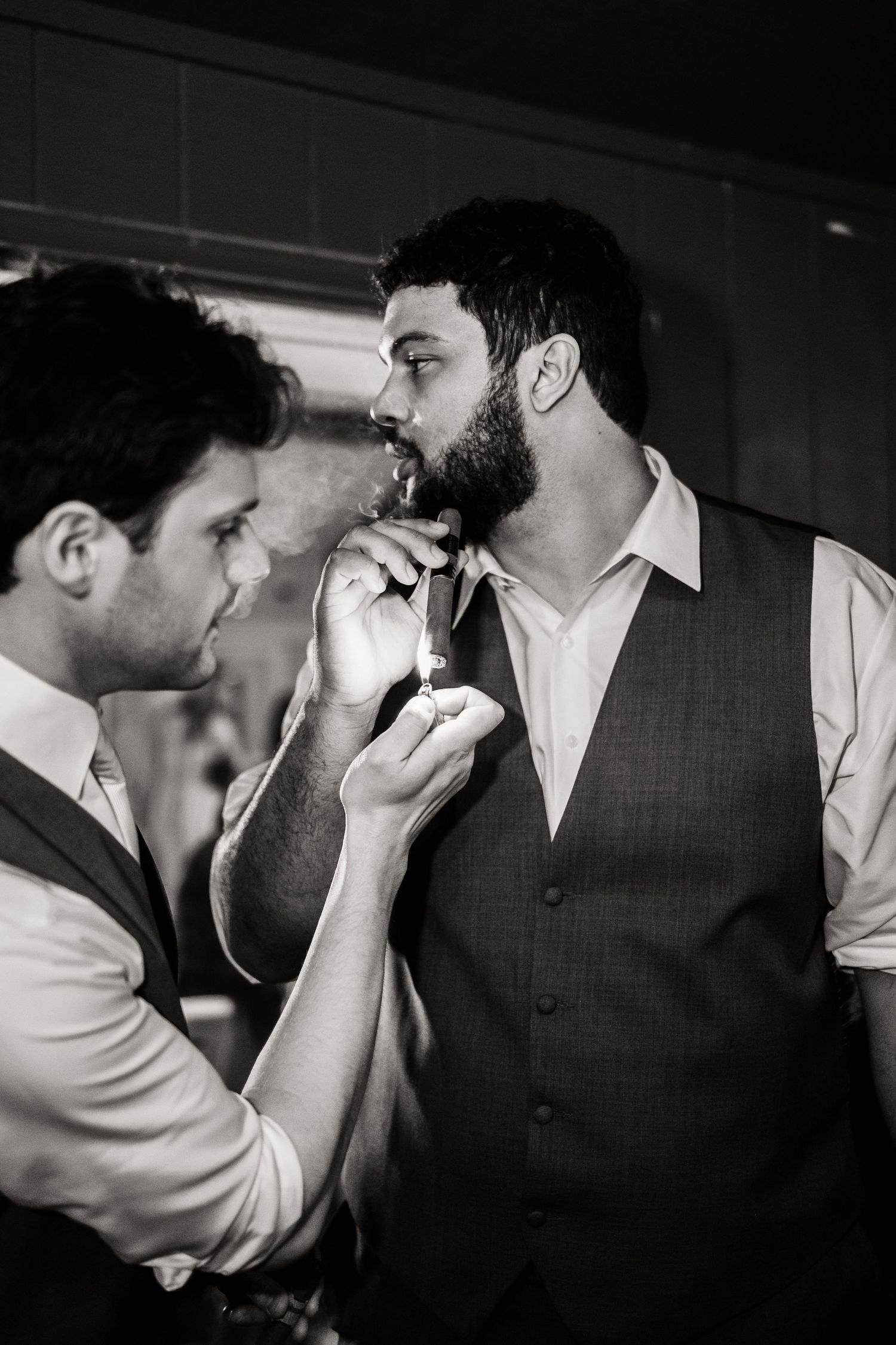 Two people in formal attire getting ready during a black and white wedding preparation moment.