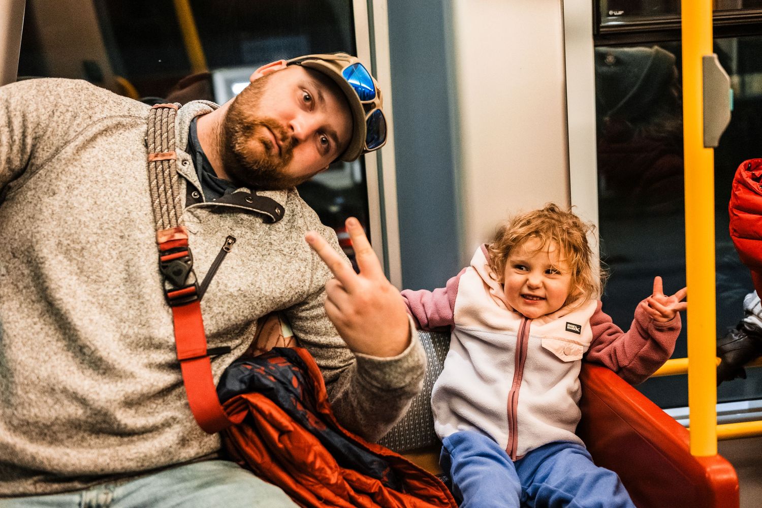A sequence of candid moments showing two people interacting while seated on public transportation.