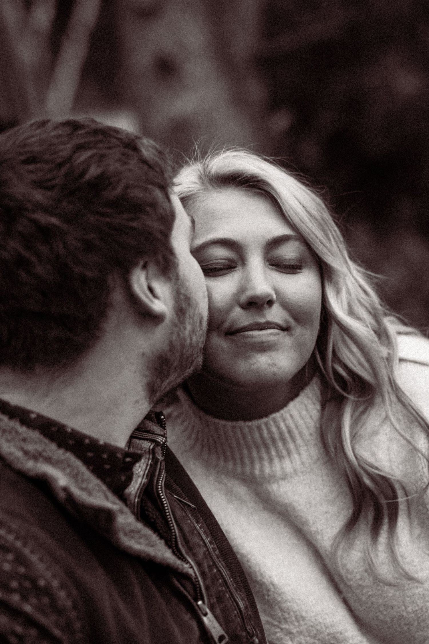 Black and white close-up series showing tender moments between a couple wearing cozy sweaters.