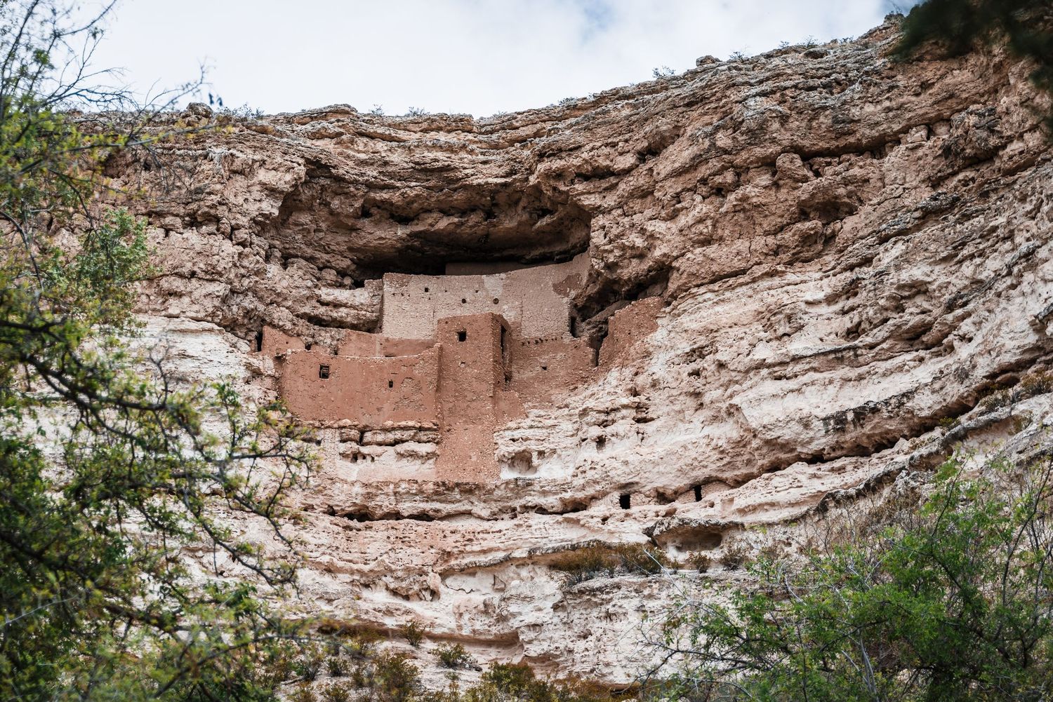 Ancient cliff dwelling nestled in limestone cave formations at Montezuma Castle National Monument in Arizona.