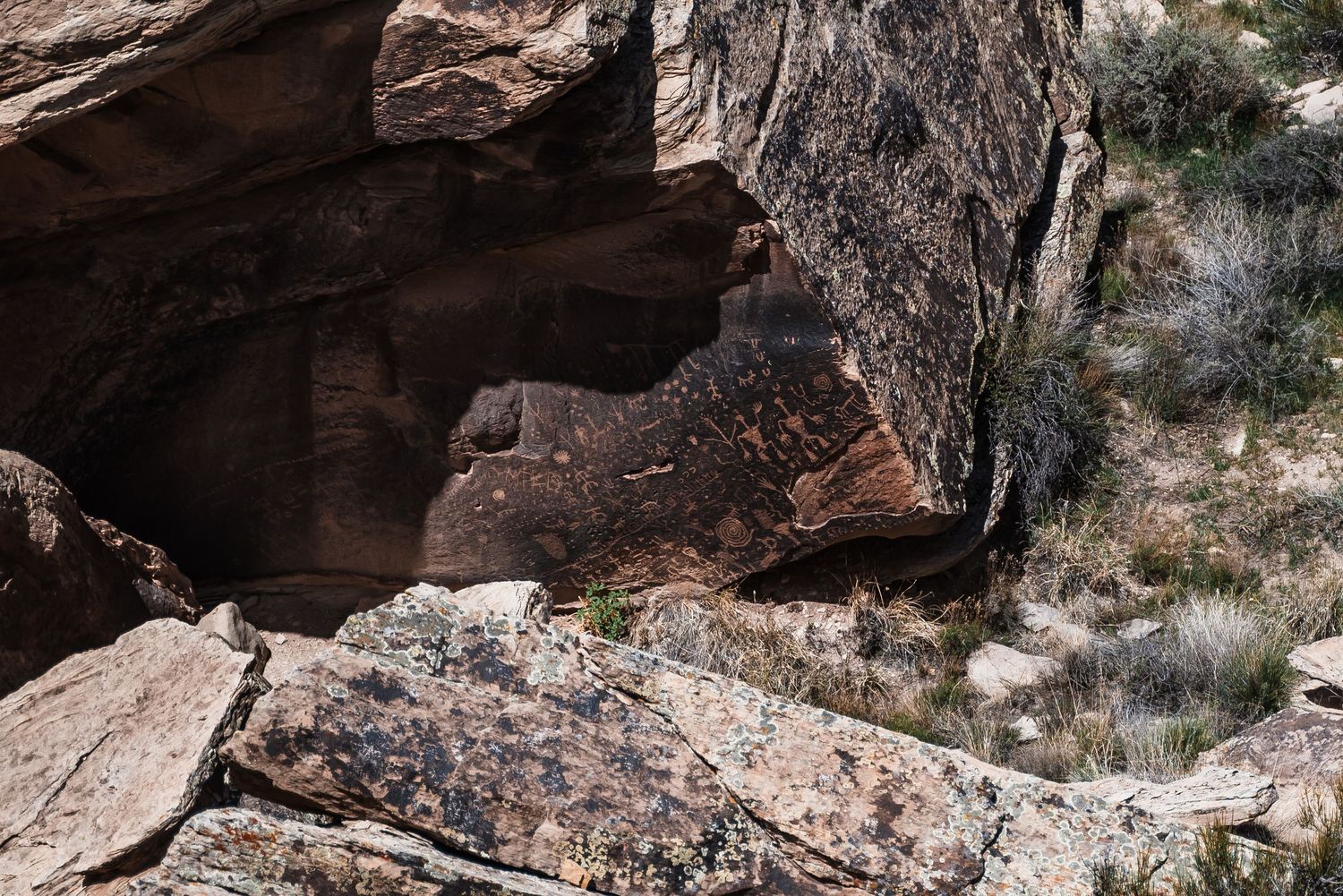 Natural rock cave entrance with layered sandstone formations.