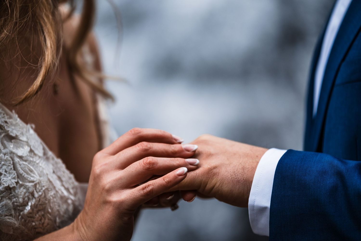 Close-up details of tender moments between a couple in wedding attire.