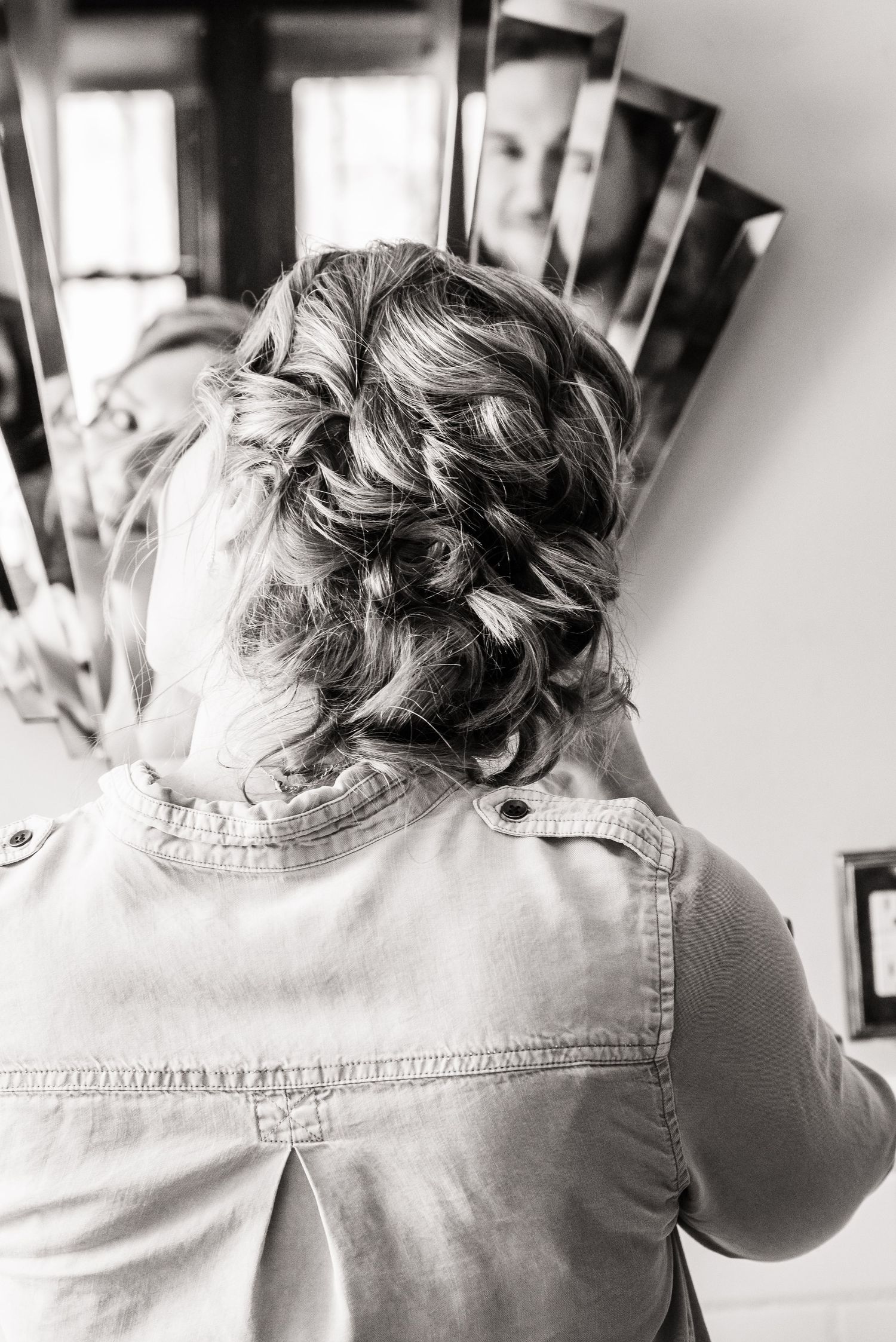 Black and white photo of an intricate braided wedding hairstyle from behind.