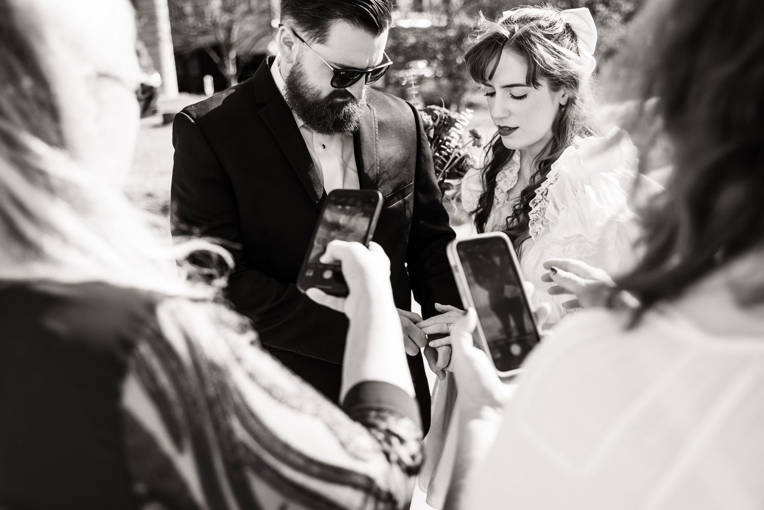 Black and white photo of couple reviewing documents during wedding ceremony.