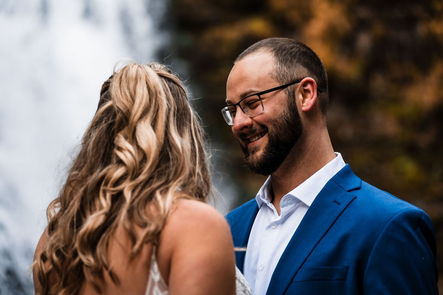 Close-up wedding portrait of couple sharing an intimate moment outdoors.